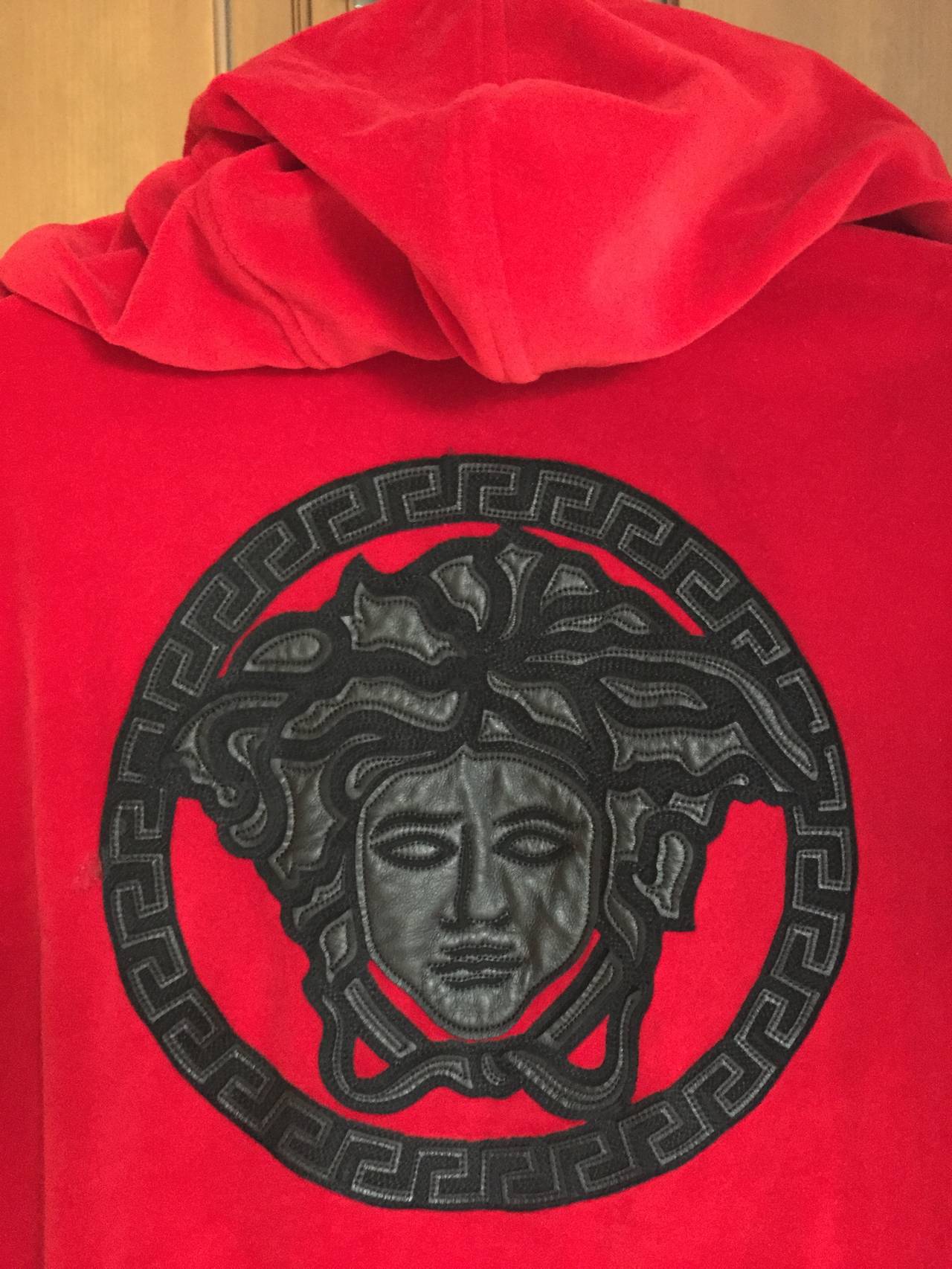 Versace Mens Velour Hoodie Track Jacket with Embroidered Leather Medusa on the Back
 sz L 
NWOT

 cotton blend velour track top from versace featuring a hood with metal tipped

 drawstrings, a gold-tone zip fastening, long sleeves with ribbed