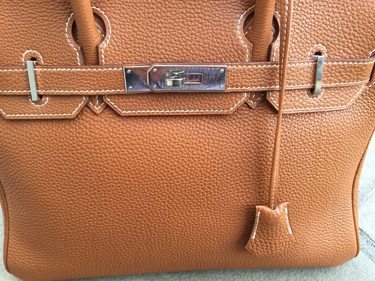 Wonderful small Birkin from Hermes.
Brown with Palladium hardware
30 cm, the perfect size.
There is no lock, just the key.
Minor surface wear at corners  and on hardware
From 2003, it is stamped with a  G in a square.