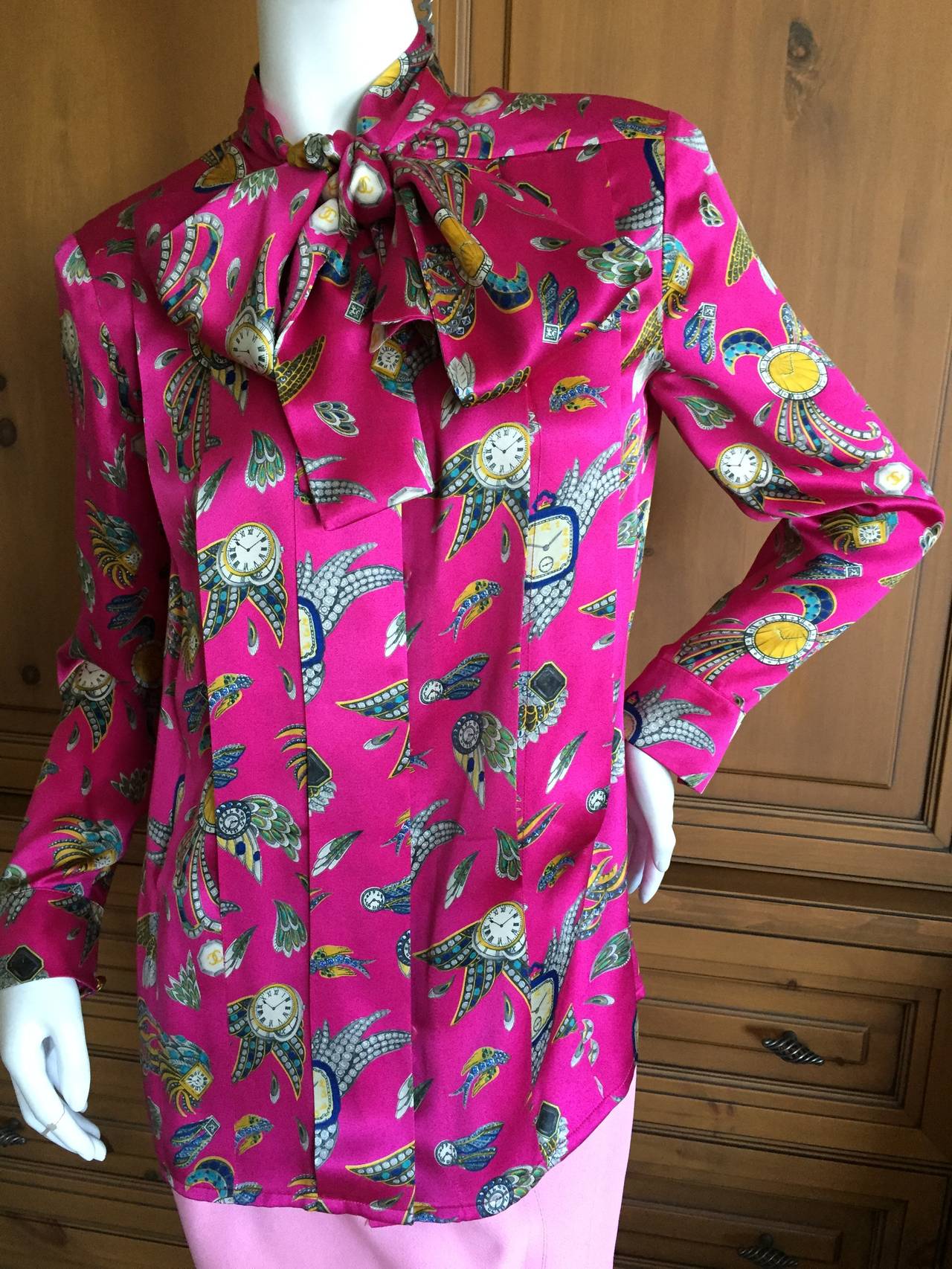 Chanel Vintage Silk Winged Jewel Blouse w Pussycat Bow.
Deep pleats and the iconic jeweled print from Karl Lagerfeld circa 1984