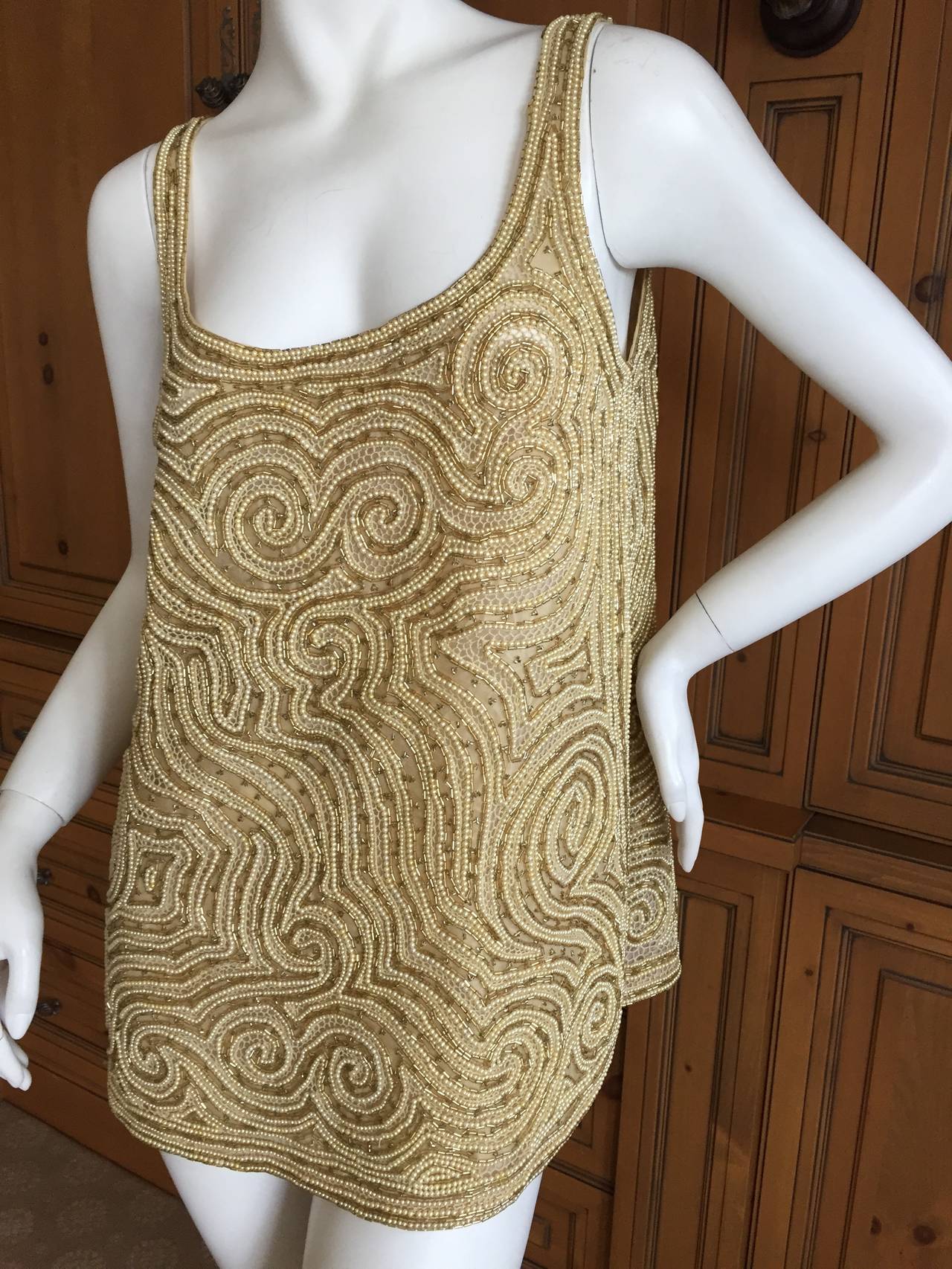 Halston 1970's Golden Pearl Embellished Top
This is so gorgeous, the photos don't quite capture the charm.
Heavily embellished with gold beads and tiny pearls.
From Amen Wardy  Newport Beach California, one of the most fashion forward stores of