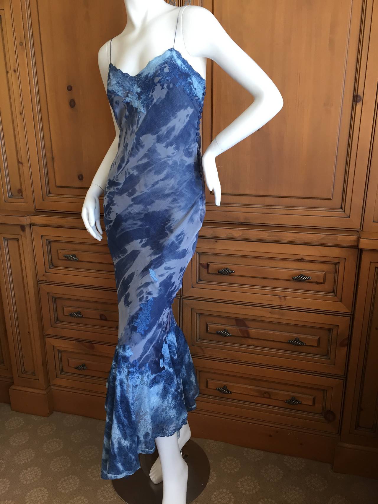 Elegant tie dye pattern silk bias cut dress from Galliano for Dior in rich shades of blue.
Subtle  tie dye cotton lace inserts throughout, this dress is much prettier than the photos show.
Side buttons