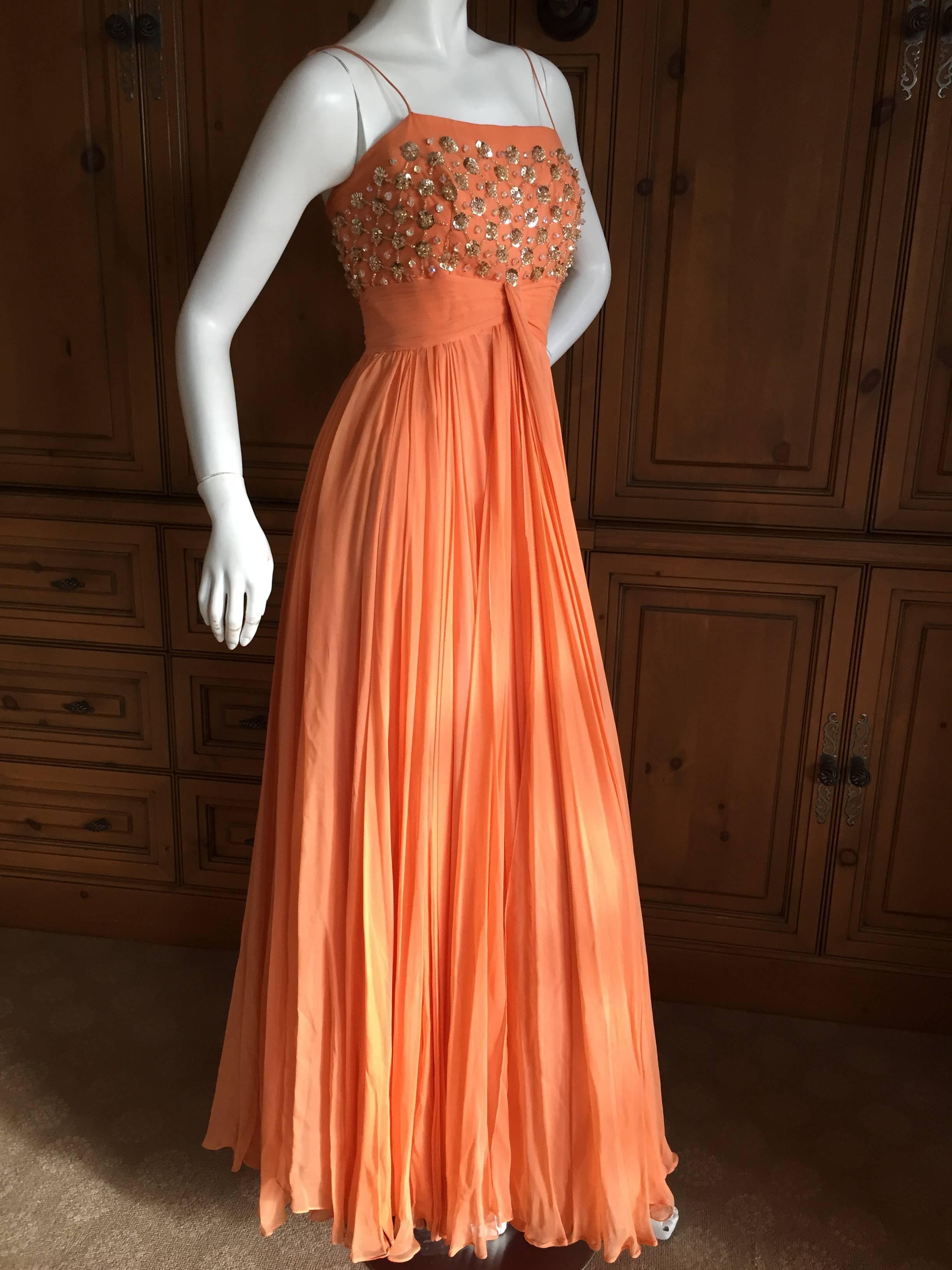 Lovely orange silk chiffon evening gown with embellished bodice from Saks Fifth Avenue circa 1950.
With miles of fabric ,this is so pretty in motion.Two layers of silk chiffon over an inside slip.
Saks Fifth Avenue had a very fine couture salon
