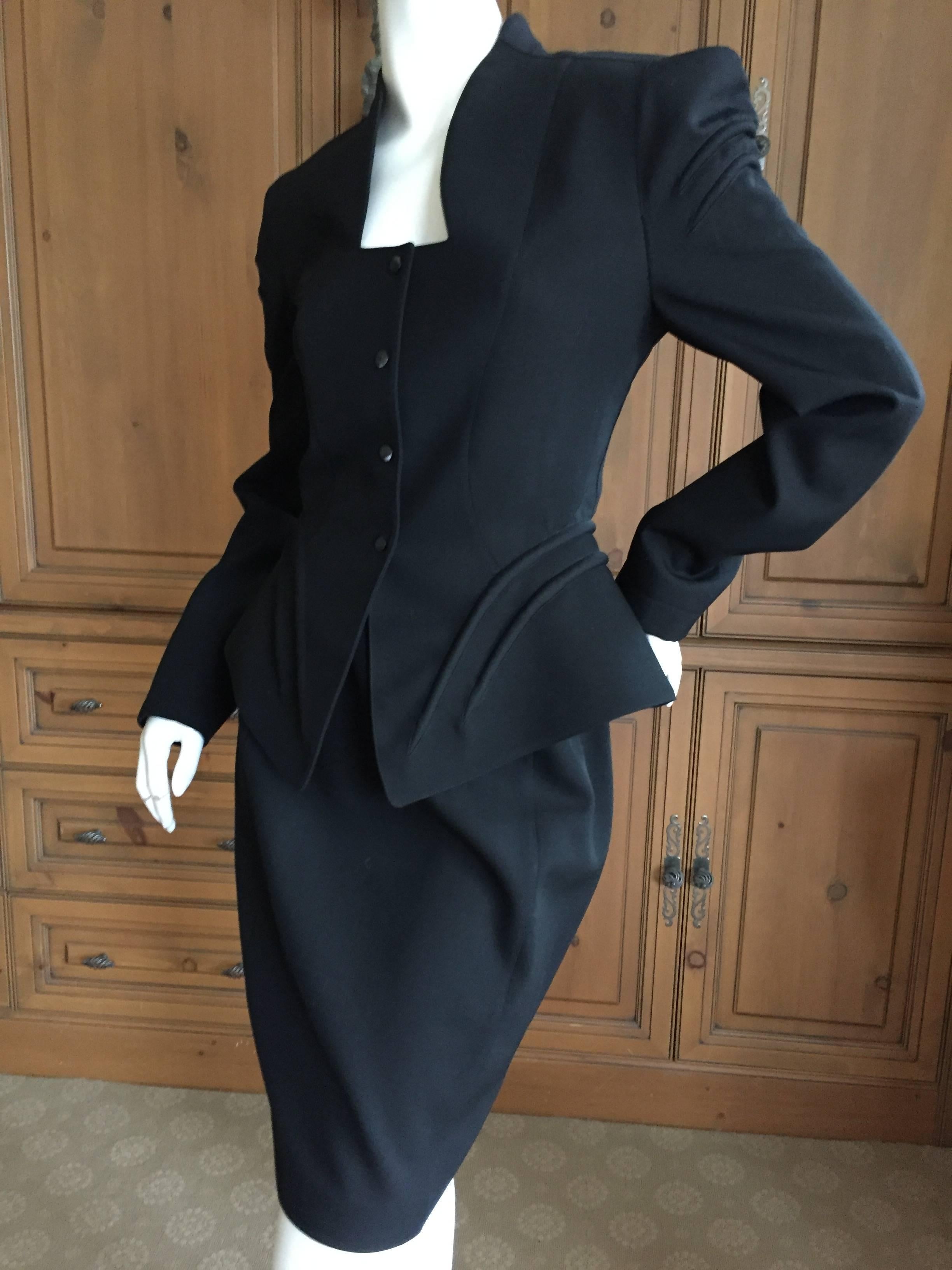 Rocking black vintage evening suit from Thierry Mugler.
Featuring a peplum snap front jacket and a pencil skirt.
Marked size 40.
Jacket
Bust 38