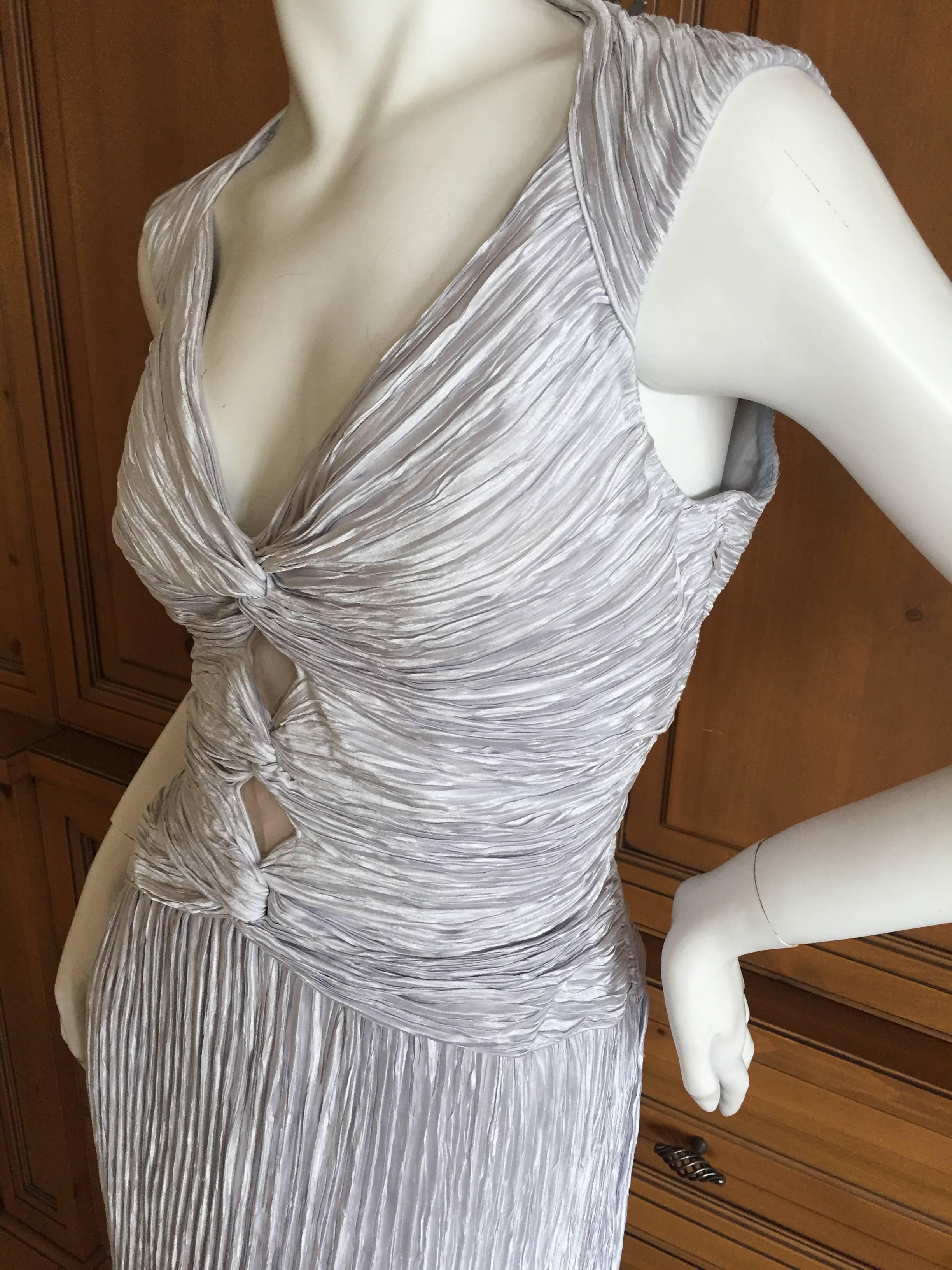Beautiful silver pleated evening dress from Mary McFadden, circa 1970's.
Size 14 
It will fit much larger size than the measurements due to the looseness of the pleating,
Bust 40" Waist 35" Hips 55" Length 55" 
Excellent