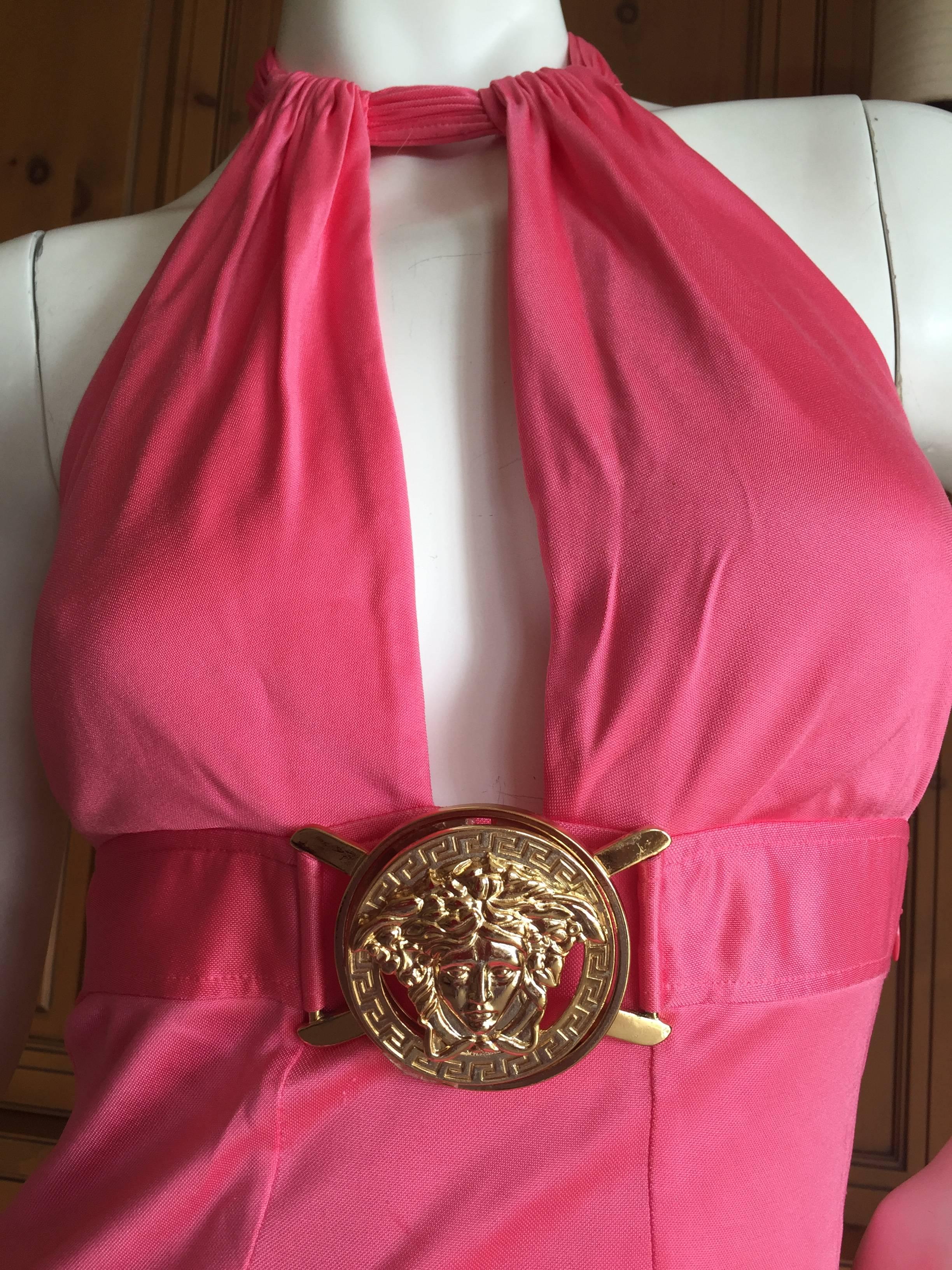 Versace Backless Pink Cocktail Dress with Large Gold Medusa Buckle.
So sexy, made of soft jersey, it ties in the back, and the belt is only onrnamental.
Unworn.
Size 42
Bust 36