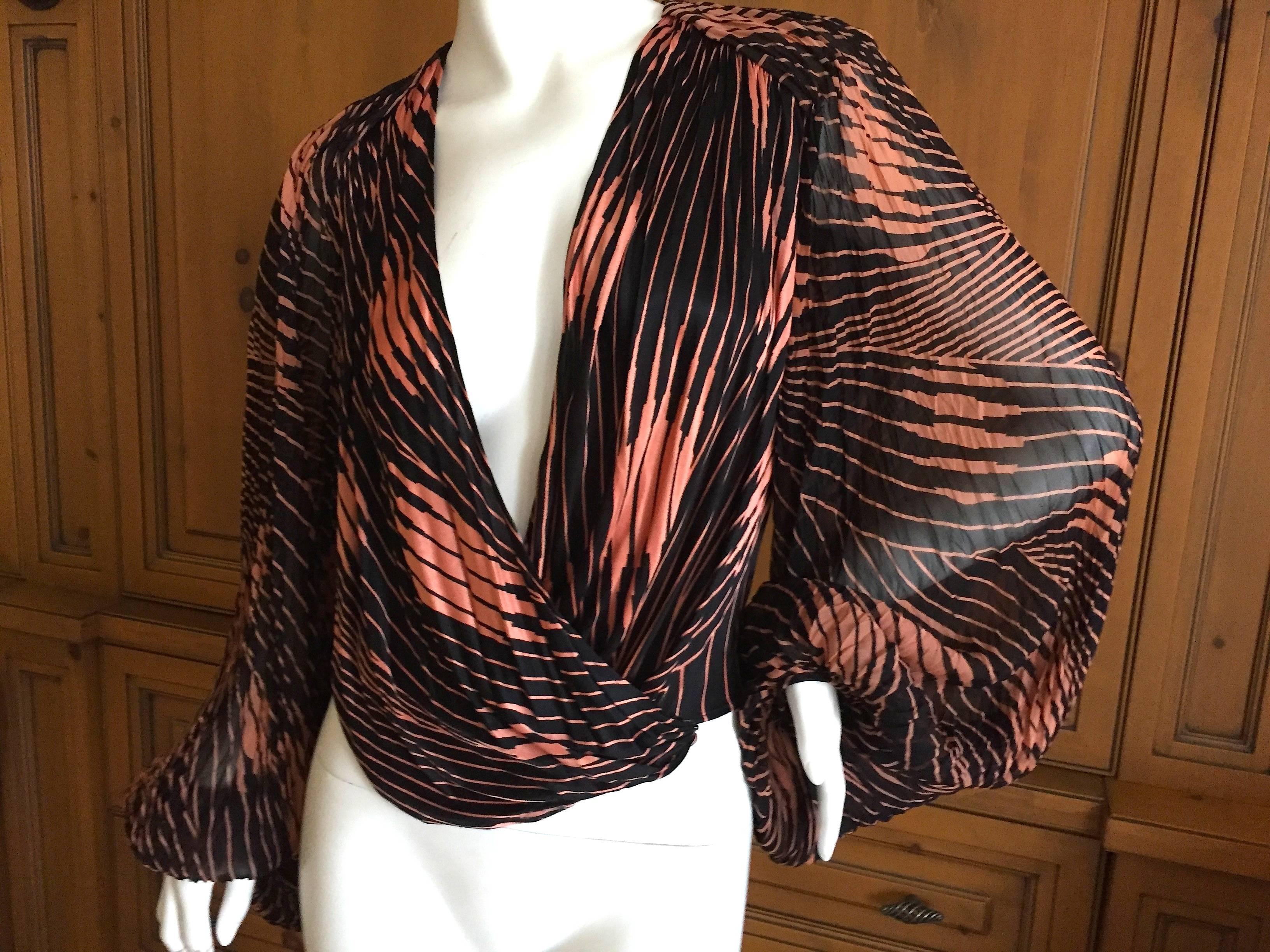 Beautifully tailored sheer low cut wrap blouse from Gianni Versace.1980's.
The details are so pretty, shirring at the shoulders and billowing romantic sleeves, pure sexiness from early Gianni Versace.