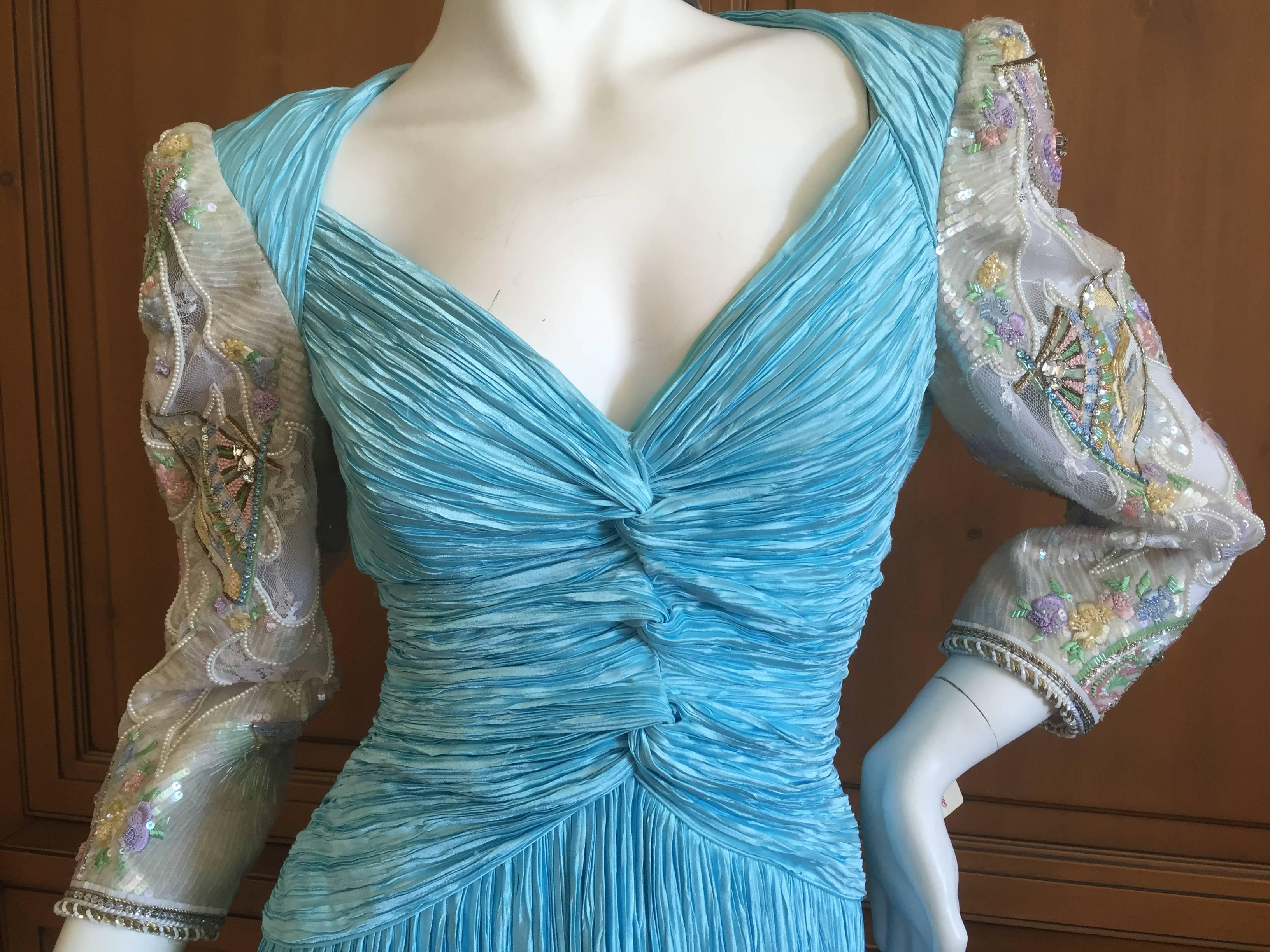 Magnificent pleated evening dress from Mary McFadden Couture.
Featuring a knot motif bust line in her signature pleated fabric, this has magnificent beading on the sleeves.
Unworn with Saks tags attached, this was $3335 in 1989.
SIze 10
Bust