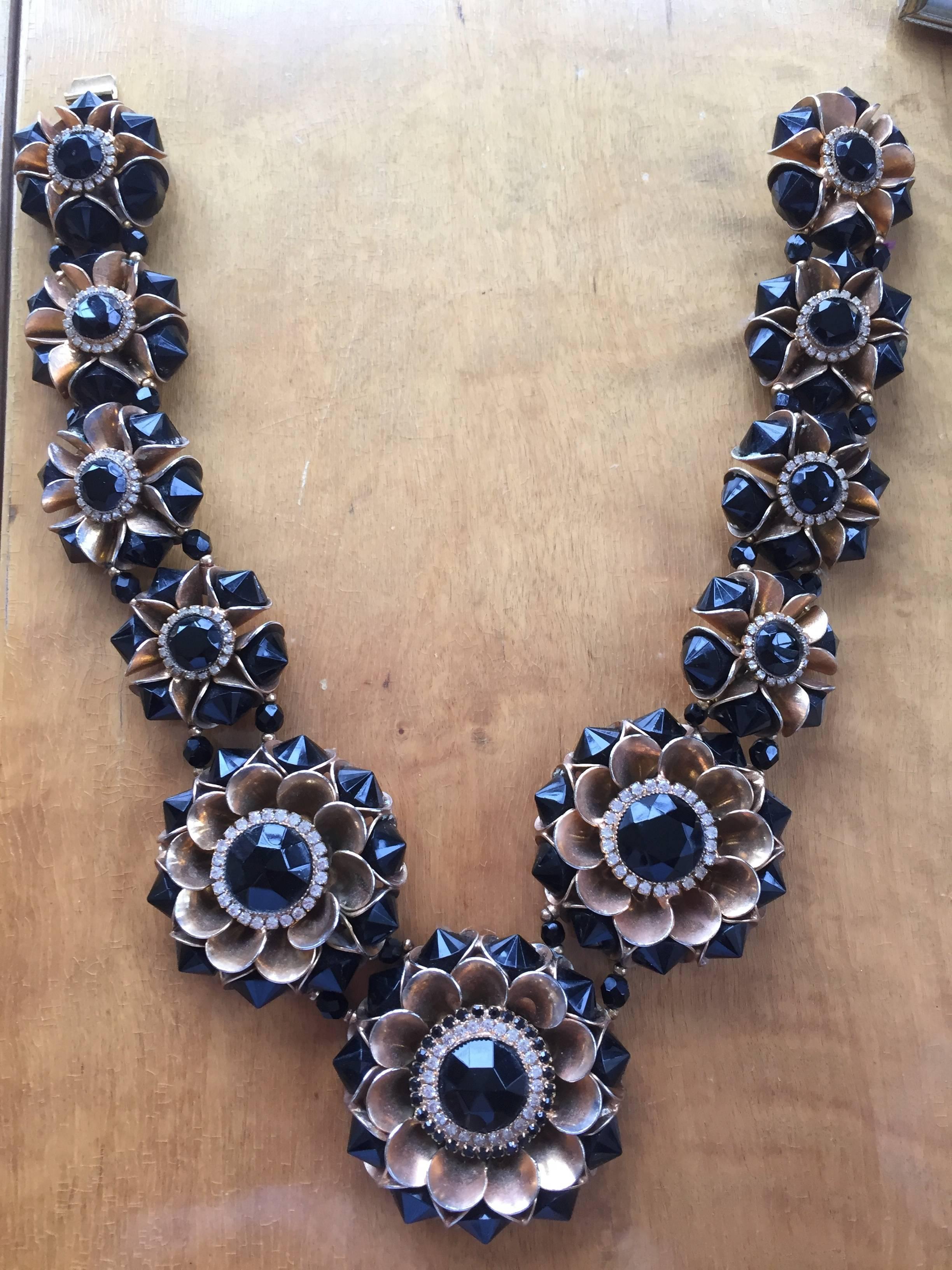 Magnificent floral necklace by William De Lillo in gold tone brass with jet and clear Swarovski crystals.
One off, this is a hand made sample.
William De Lillo was a jeweler with a background in fine jewelry who designed for Miriam Haskell for