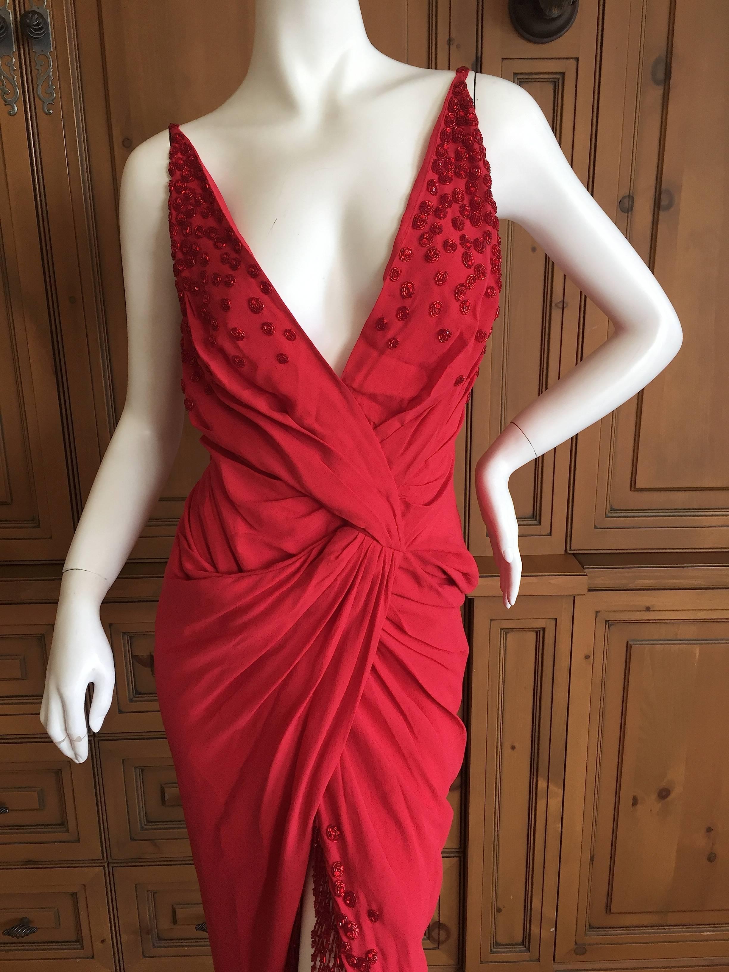 Beautiful red evening dress from John Galliano.
Trimmed in red beaded fringe with bead florettes at the bust.
Photos don't quite capture the charm of this dress, the fringe is really special.
Size 38
Bust 40