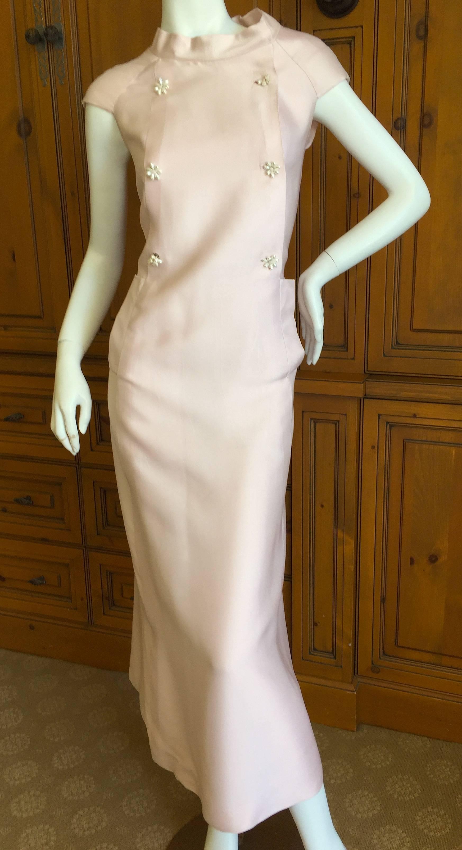 Beautiful pale pink silk twill dress from Christian Dior, circa 1960.
Numbered tag, this is from the Couture, appx circa 1960.
It is styled as a loose fitting shift dress, I have shown it with and without being clamped in the back to show how it