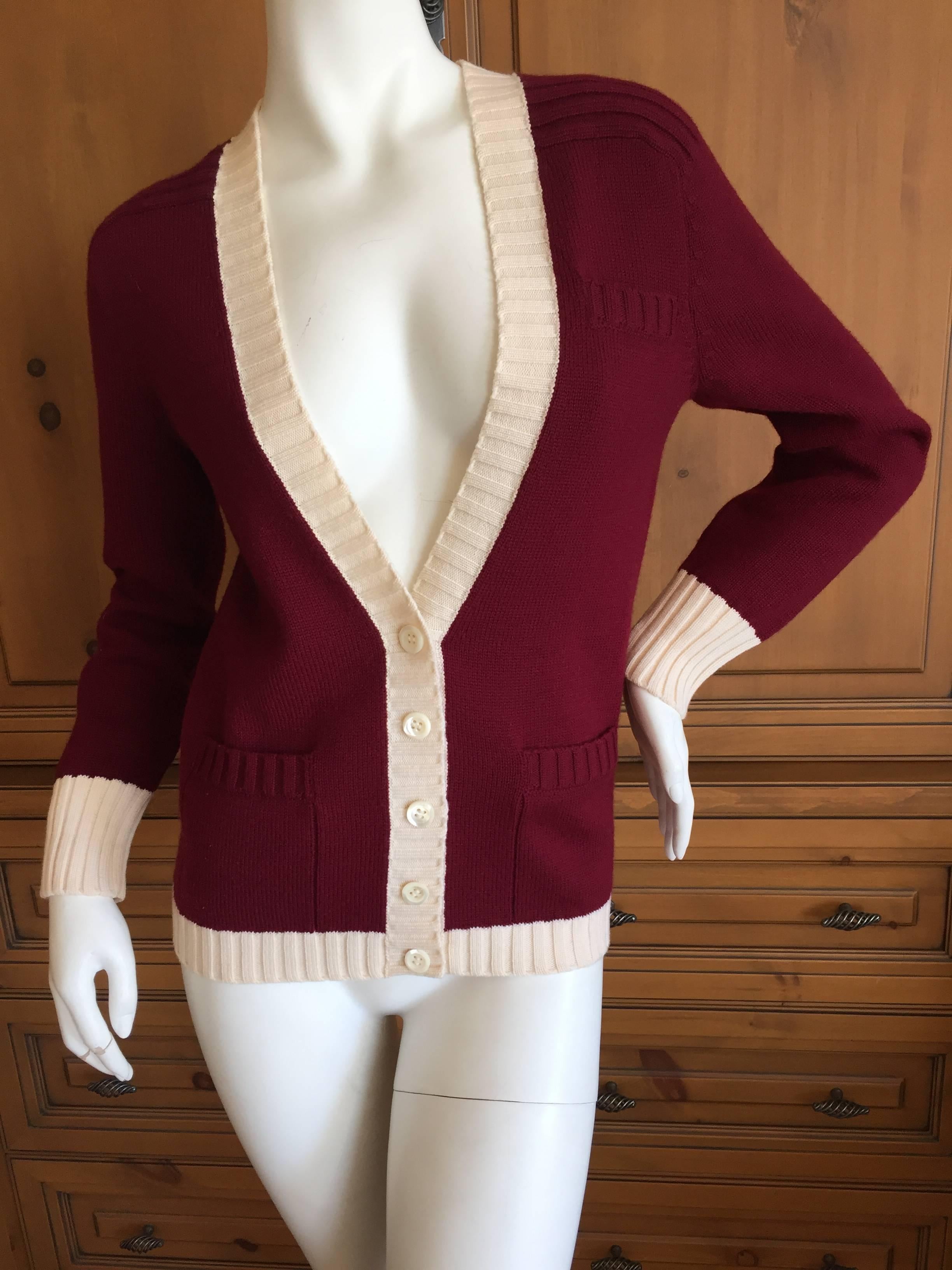 Burgundy wool cardigan with ivory ribbing from Yves Saint Laurent, pre Rive Gauche. The label is the older Cassandre Logo lable, before the creation of the pret a porter Rive Gauche line.
Marked size 1
Bust 40
