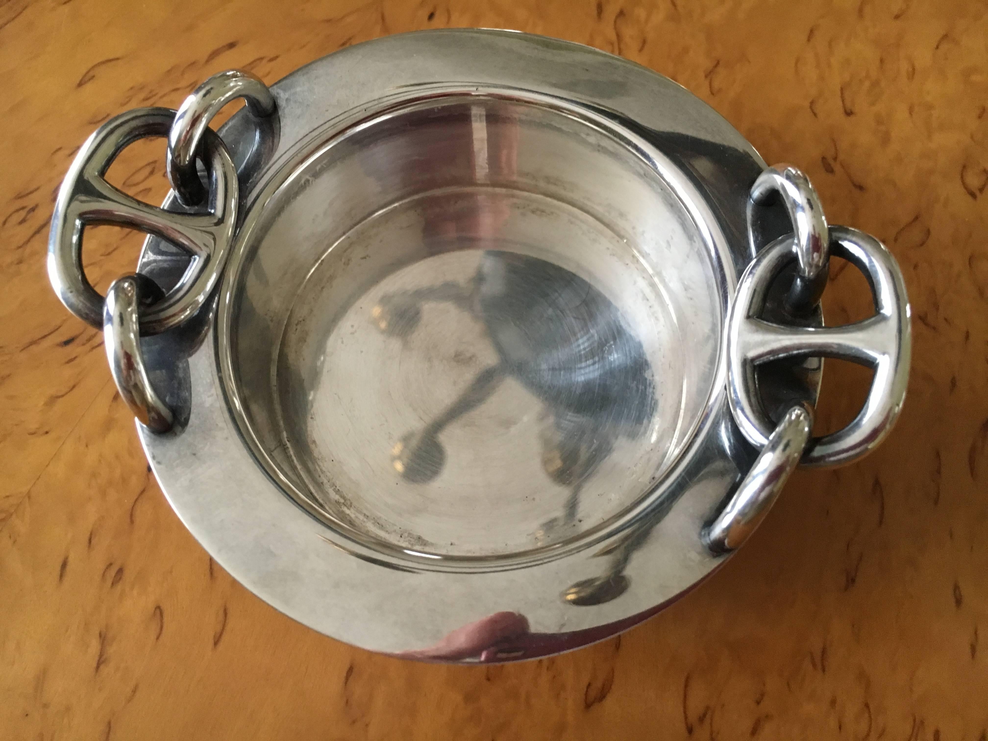 Beautiful silver plate bowl /candle holder from Hermes Paris.
There is an original candle included, but this can be utilized as a small candy bowl.
Made in France
Minor surface wear. 
The candle metal case has a ding, as is obvious from the