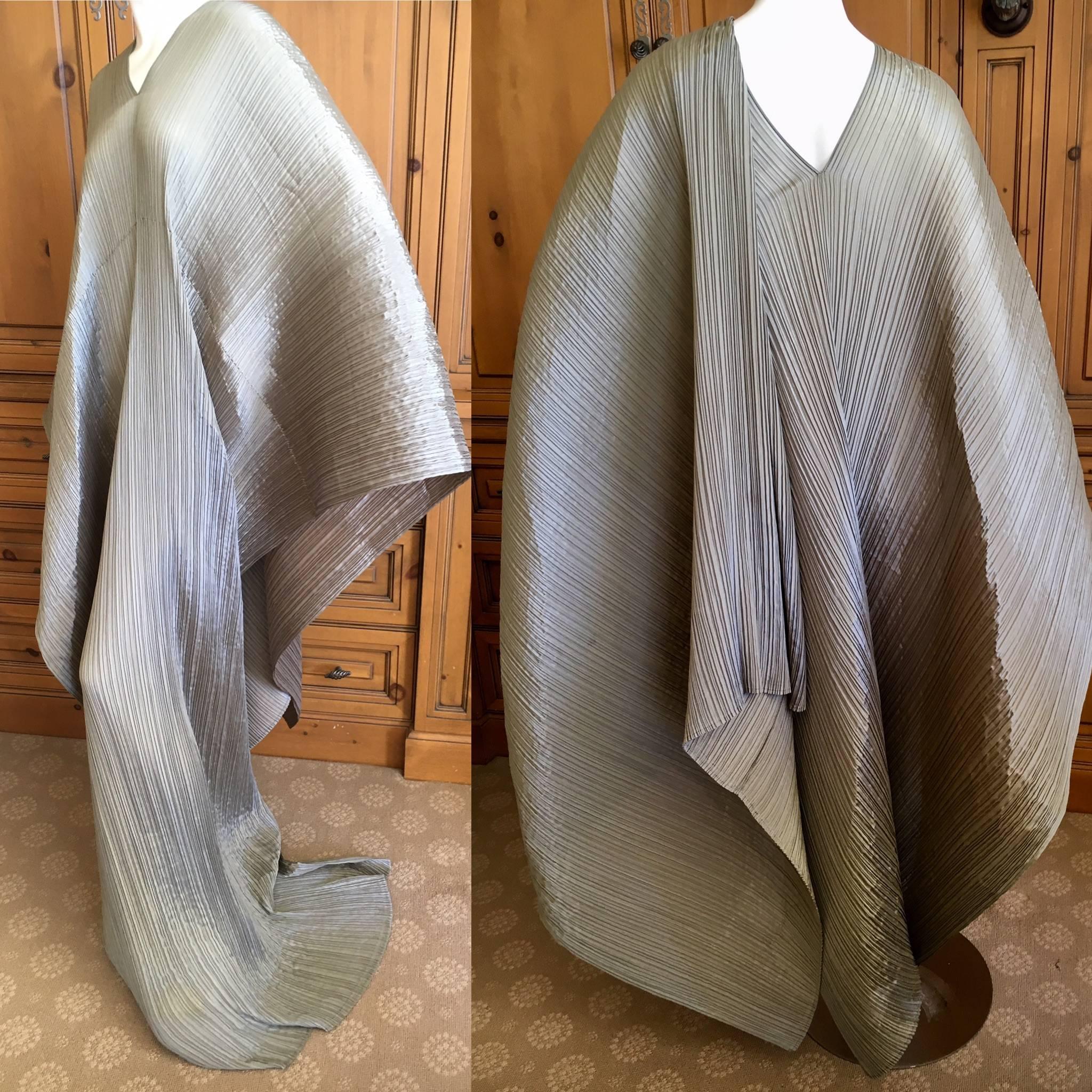 Wonderful pewter color pleated poncho from Pleats Pease Issey Miyake
A timeless classic for the collector.
Longer at the front, styled with the long part over the shoulder

Length 78