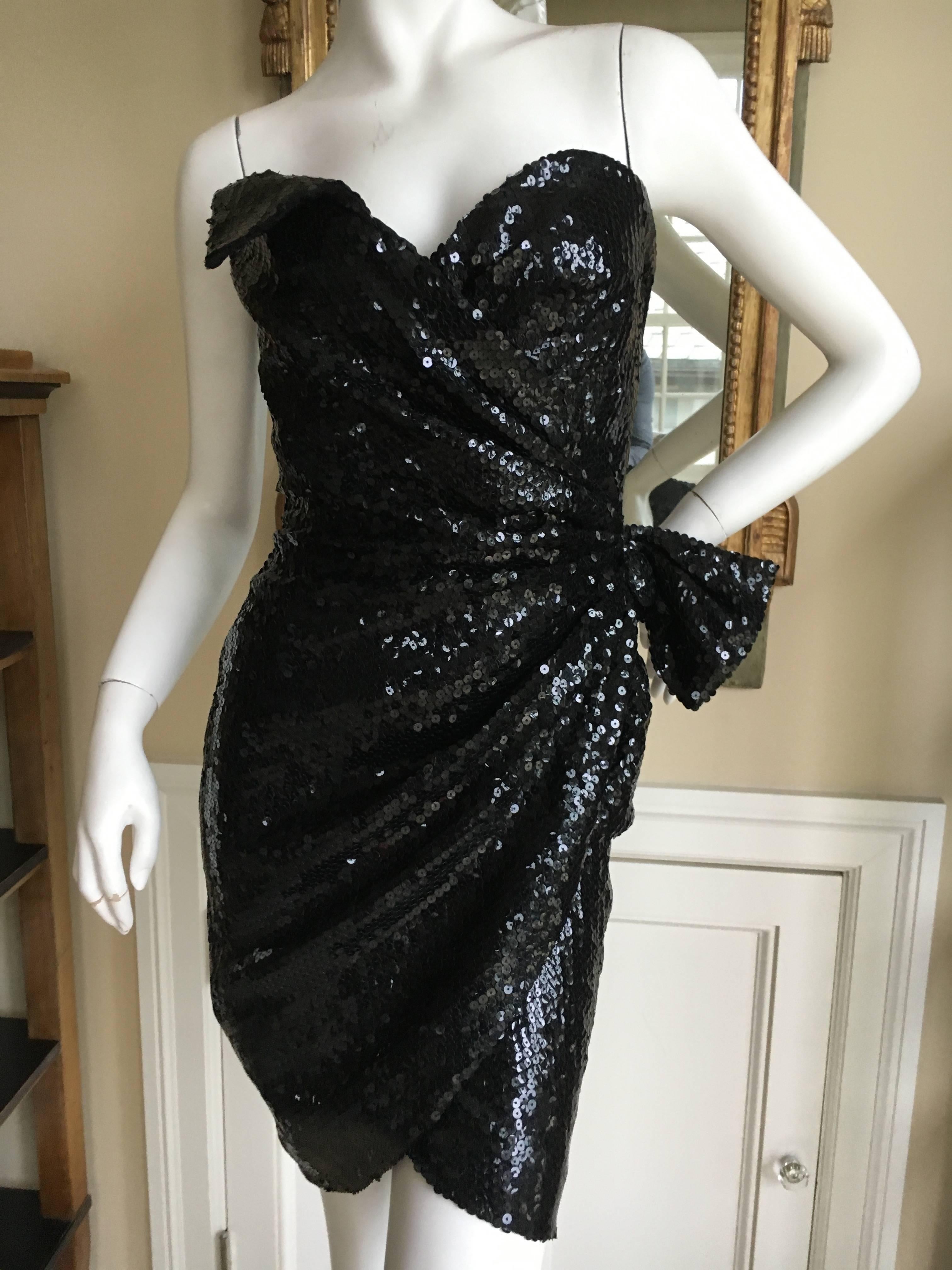 Sexy vintage black sequin cocktail dress from Thierry Mugler .
This has a wrap style section that crosses and attaches with a snap on the side.
Size 38
Bust 34"
Waist 27"
Hips 42"
Length 32"
Excellent condition