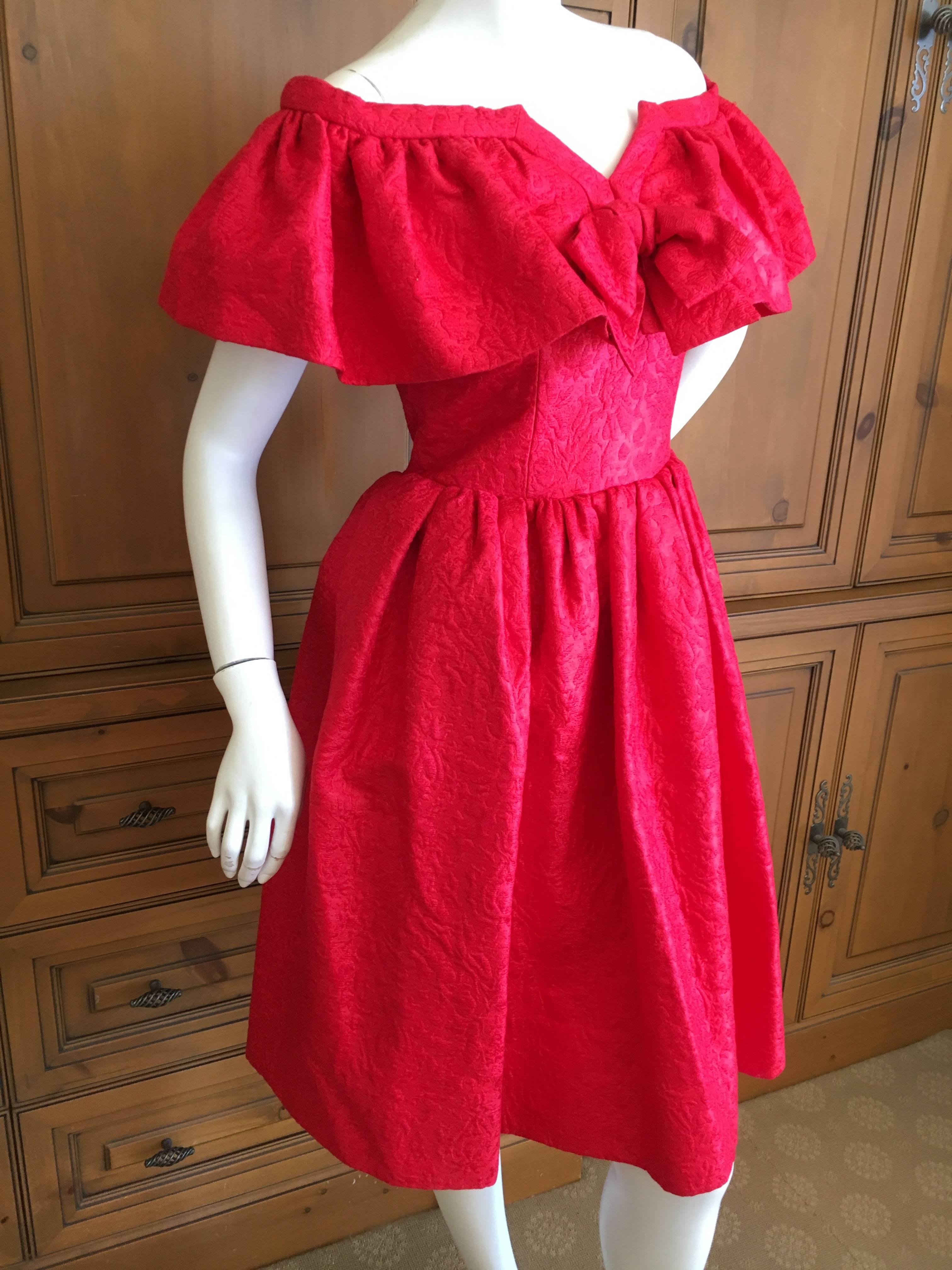 Yves Saint Laurent 1970's Rive Gauche Off The Shoulder Jacquard Dress.
Created of scarlet red jacquard with an off the shoulder capelet and delightful center bow, the skirt is very full.
SIze 40
Bust 39"
Waist 28"
Hips 40"
Length