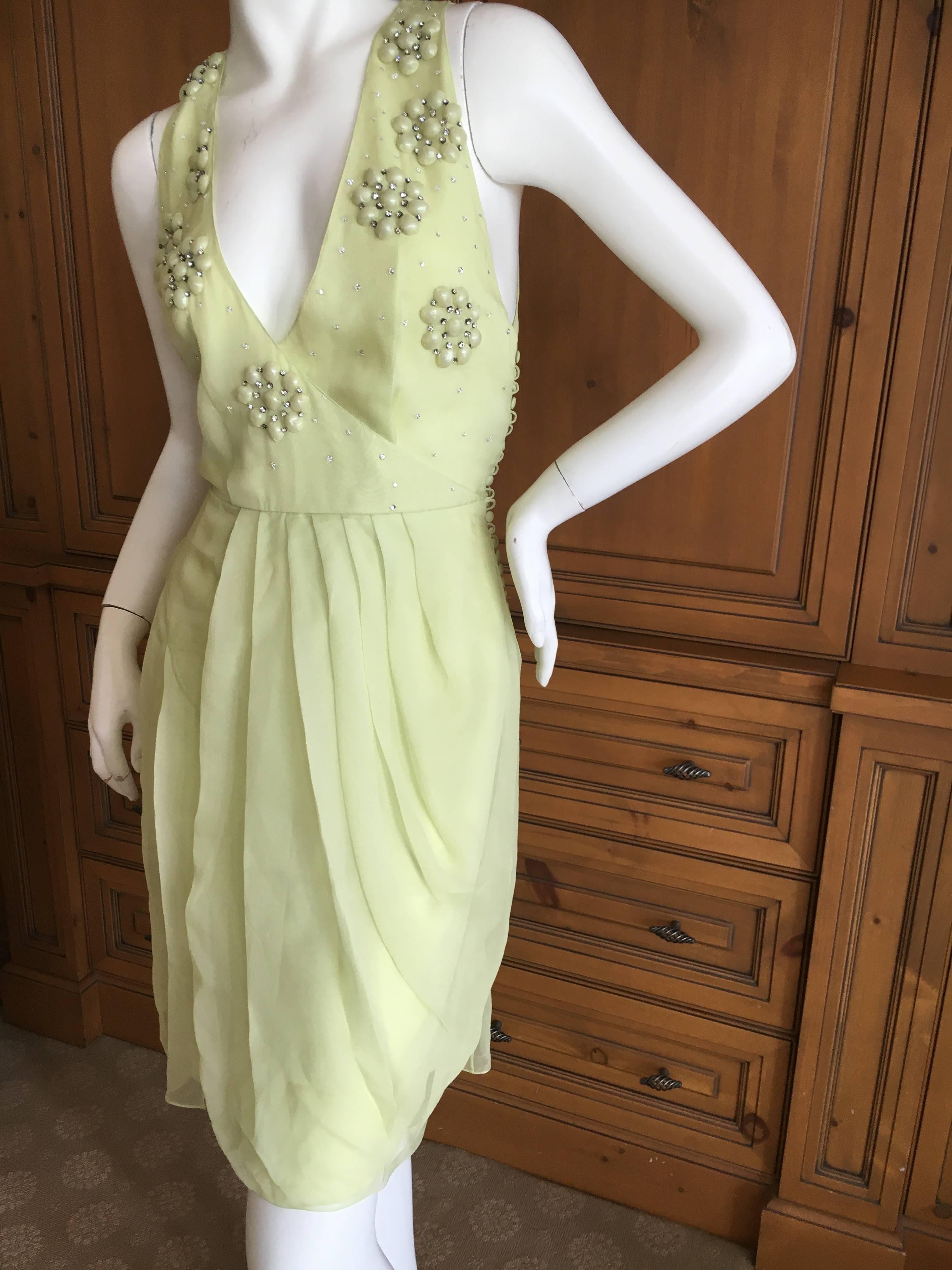 Wonderful pale green silk chiffon dress from Christian Dior.
I'm not certain if this is Galliano or Ferre.
Embellished with stylized florette's , created with pearl cabachon's covered in the green silk with crystal accents
Size 38
Bust
