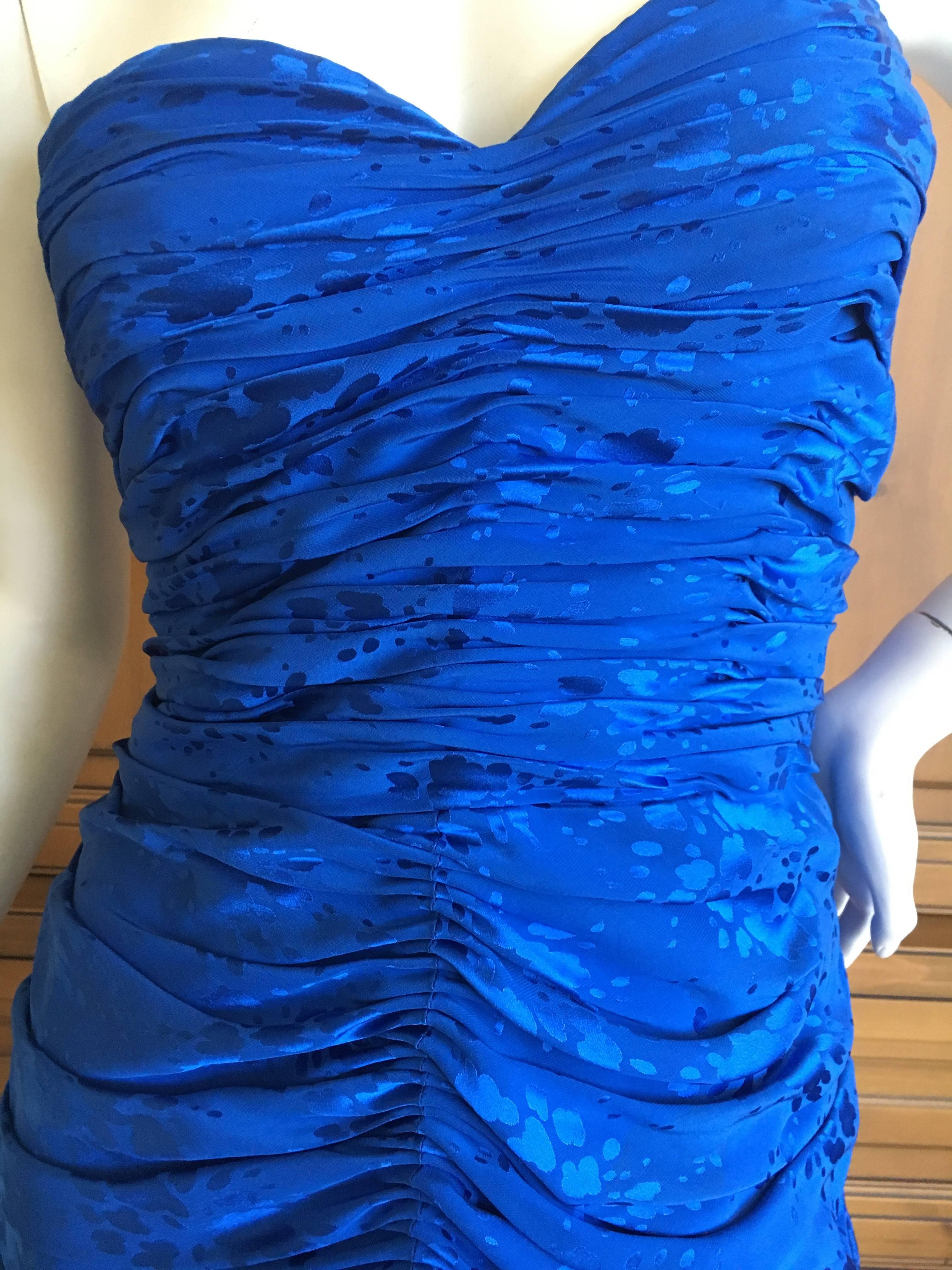 Loris Azzara Couture 1970's Ruched Blue Silk Evening Dress.
This is such a pretty piece. There are ruffle embellished straps , attached by a slim cord, which could easily be removed to wear it strapless.
Inner corset.
Bust 38"
Waist