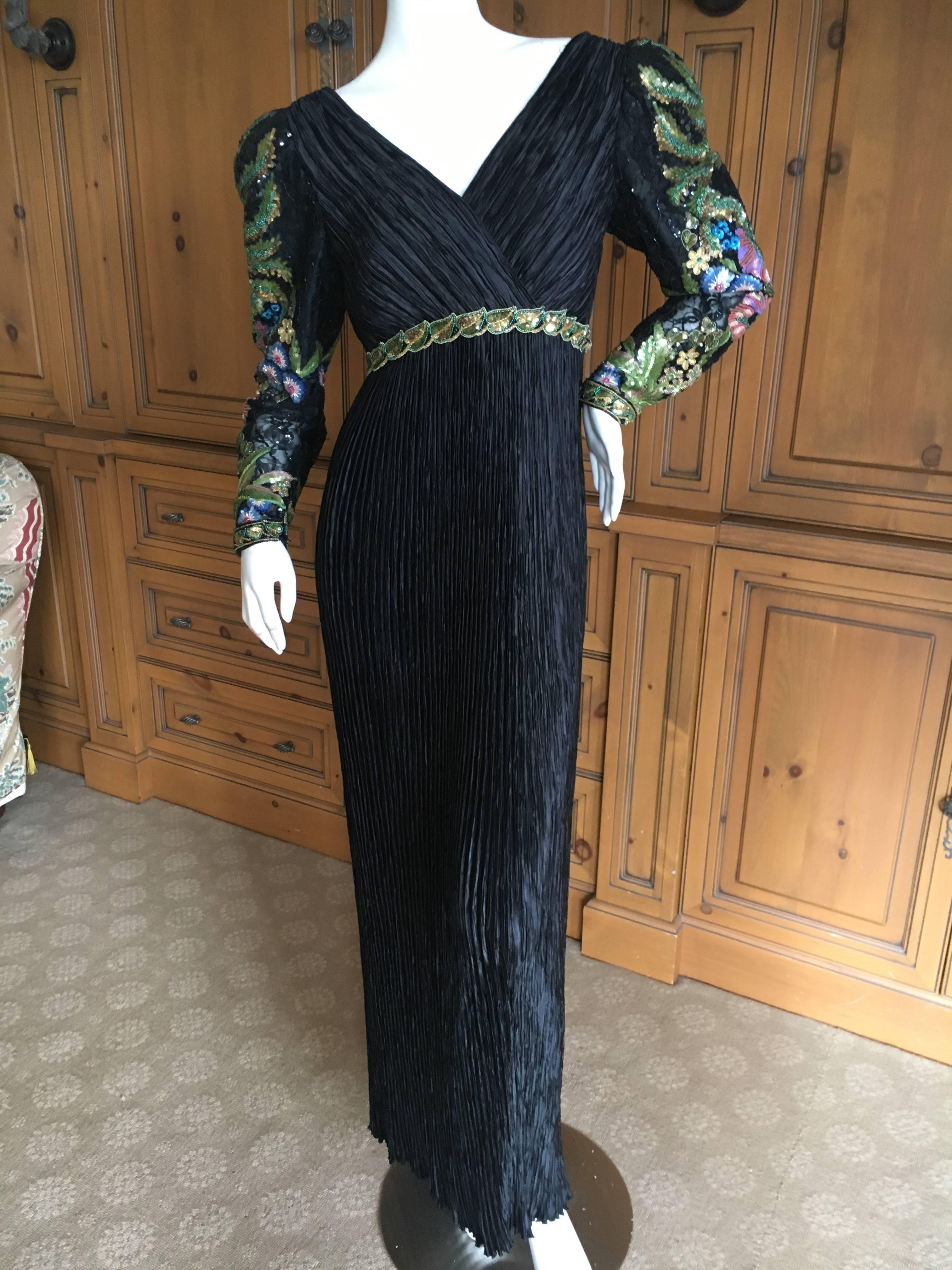 Mary McFadden  Couture Low Cut Black Plisse Pleated Dress w Beaded Sleeves
Size 6
Bust 38"
Waist 29"
Hips 48"
Length 61"
Excellent condition