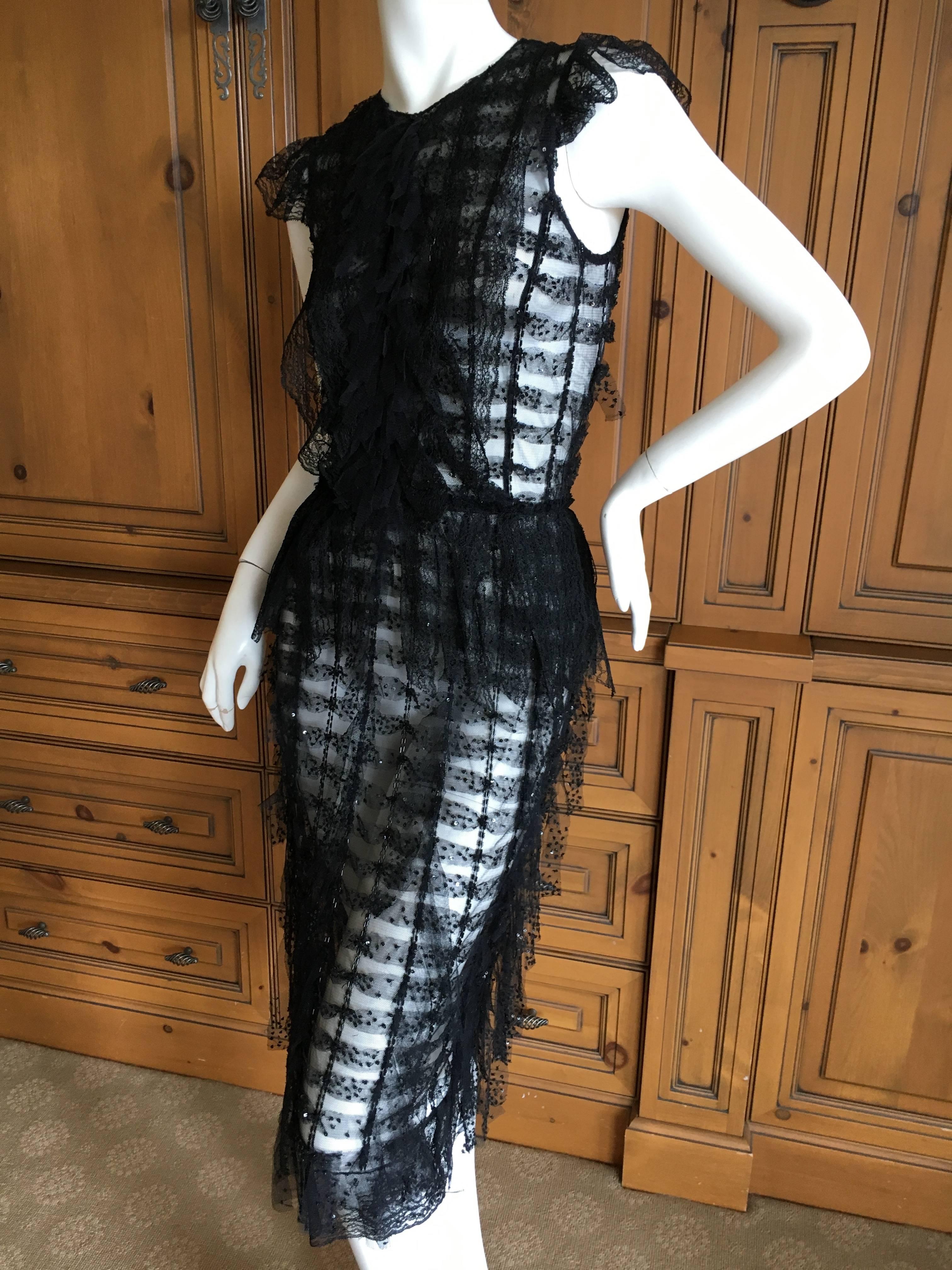 Oscar de la Renta Sheer Black Bugle Bead Embellished Cocktail Dress with Slip.
This is so pretty. The slip can be worn separately , and the dress is sheer, it would look amazing with just sexy black undergarments.
Size 2
Bust 36"
Waist