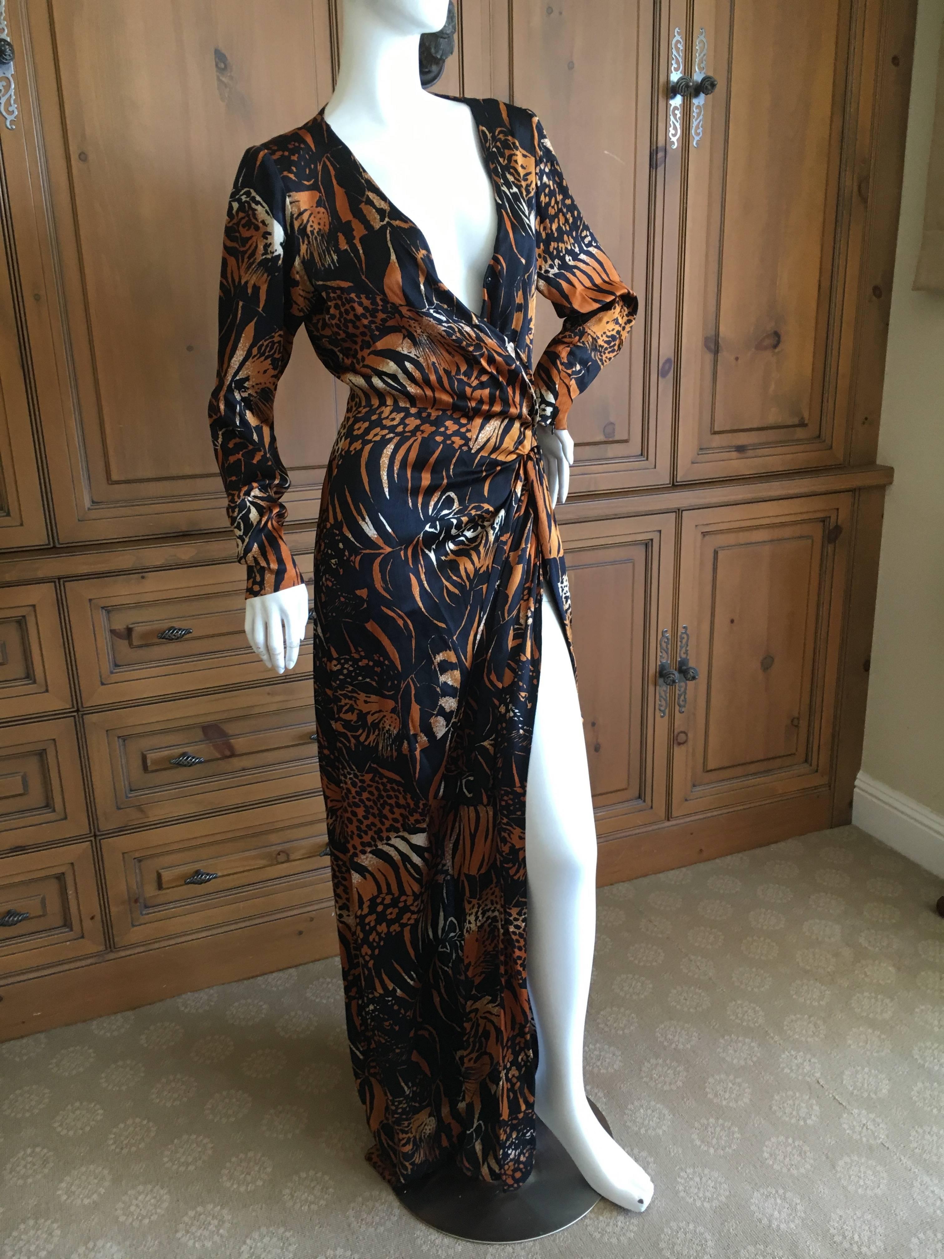 Yves Saint Laurent Rive Gauche Vintage 1980's Tiger and Leopard Print Long Dress.
This is a wrap style, which closes with hook's and eyes.
There is a button higher up on the neck for modesty, but I show it unbuttoned .
This is a sensational dress,
