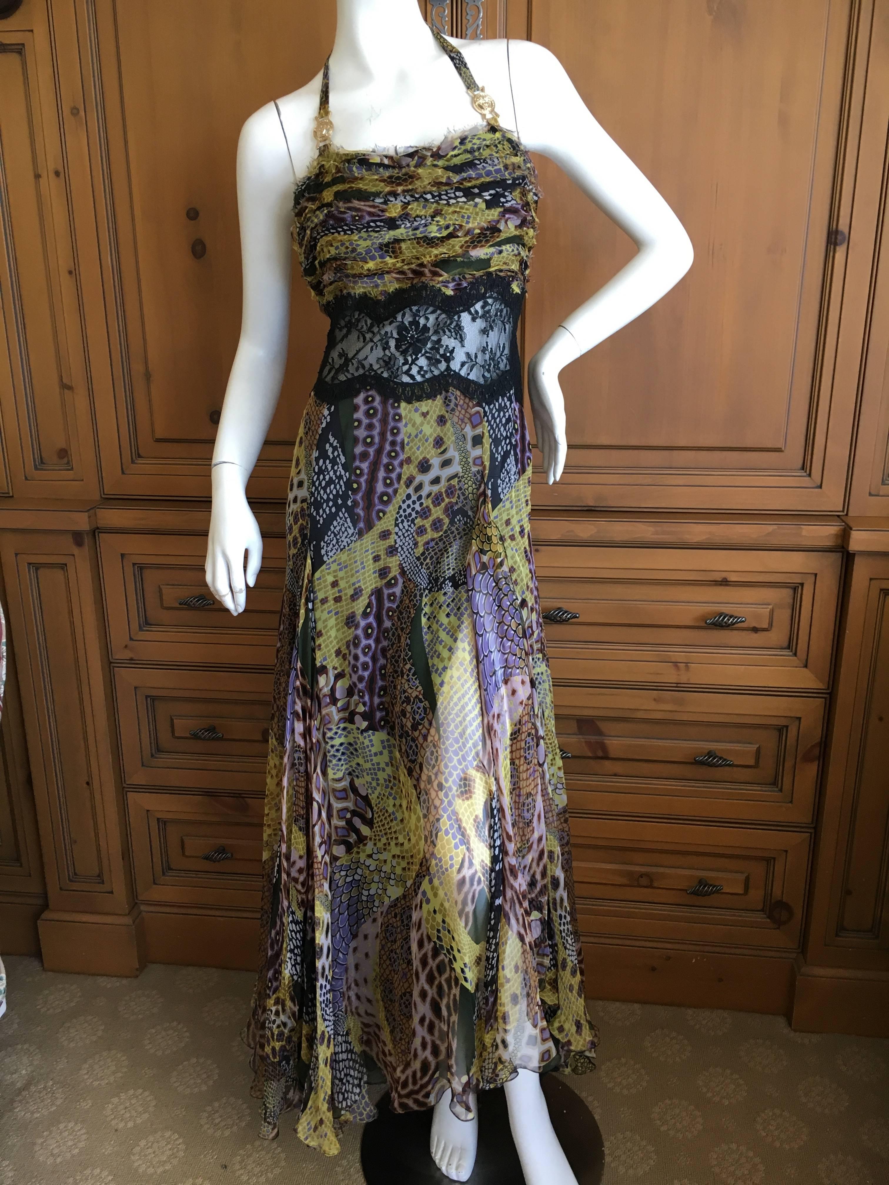 Versace Vintage 90's Snake Print Dress with Sheer Lace and Medusa Ornaments
Size  44
 Bust 36"
 Waist 29"
 Hips 42" 
Length 60" 
Excellent condition, there are some tiny blemishes in the fabric on the back near the bottom hem,