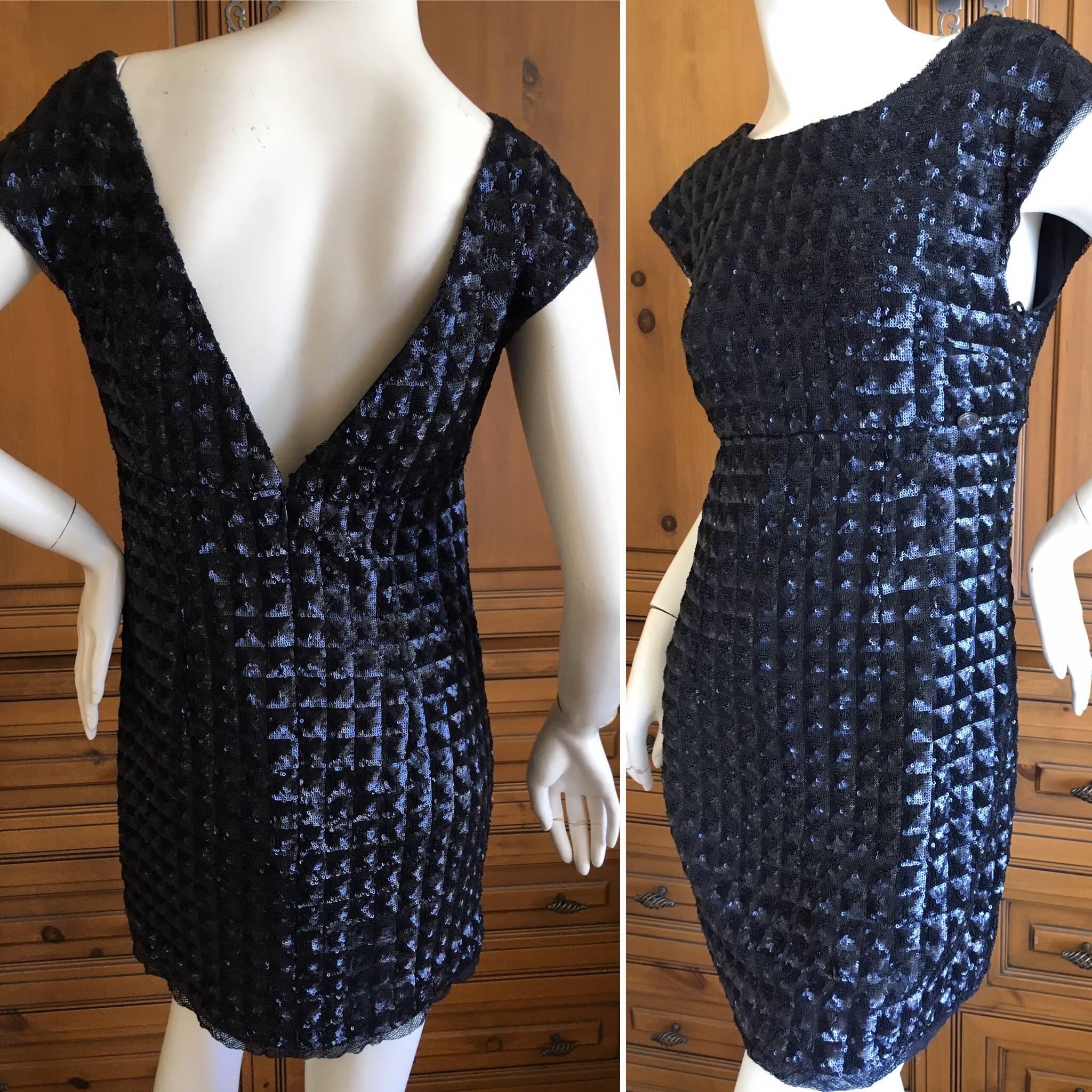 Wonderful navy blue sequin mini dress with deep see back.
Completely embellished with navy blue sequins in quilted pattern.
Size 36
 Bust 36" 
Waist 30" 
Hips 40"
Length 31"  
Excellent pre owned condition
