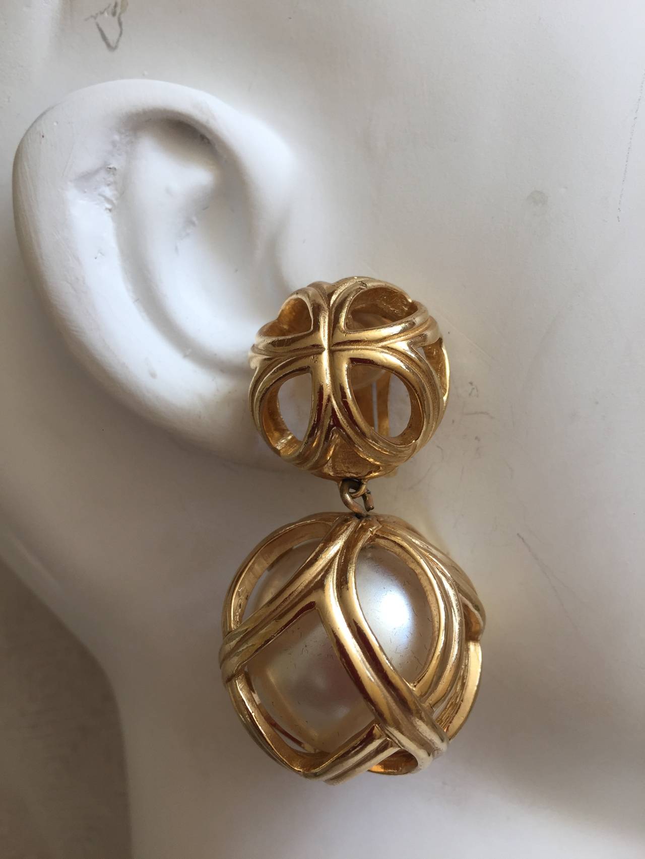 Christian Dior by Grosse Pearl Cage Drop Earrings.
Clip earrings with a dangling cage suspending a large pearl, so chic.