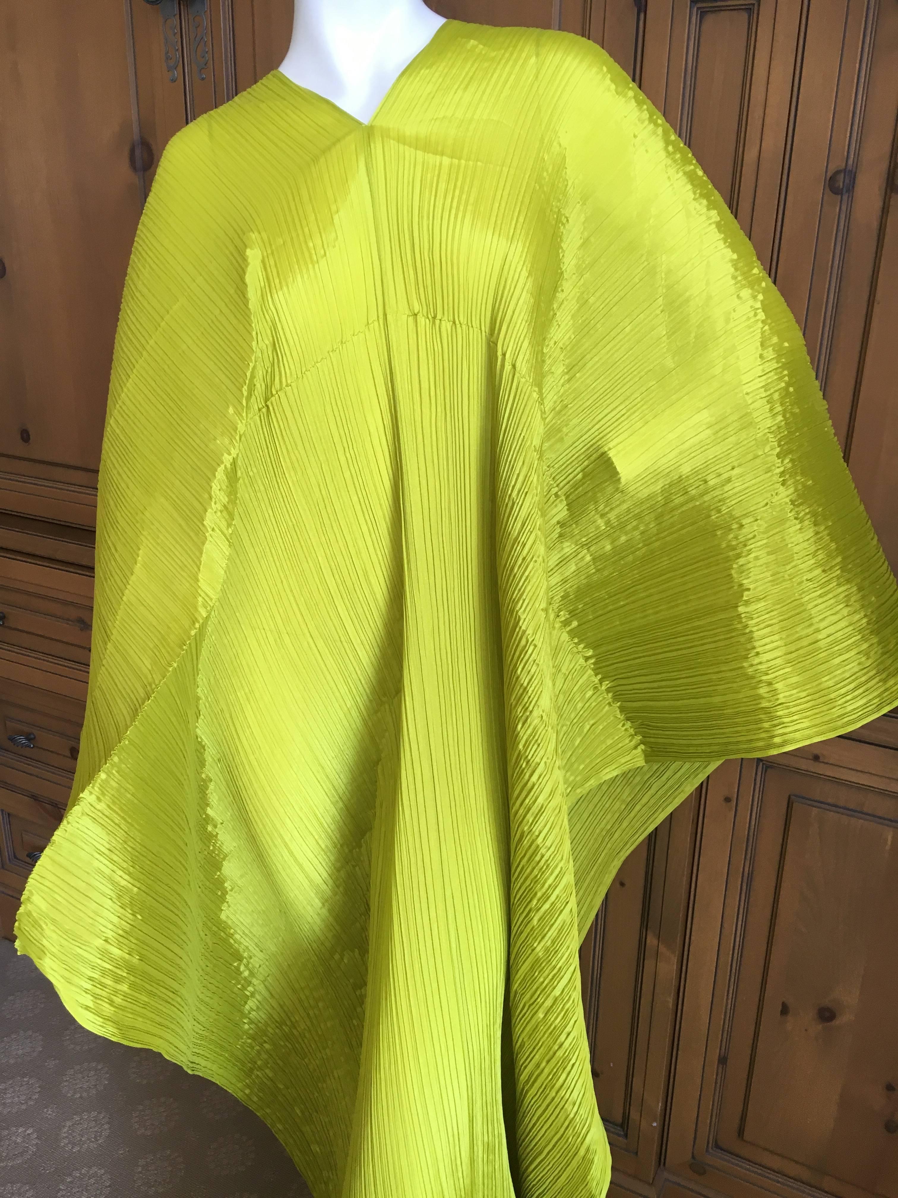 Issey Miyake Sculptural Neon Green Pleated Poncho by Issey Miyake Pleats Please, circa 1999.
Such a wonderful color.
Pleats please is so easy to wear and travel with, it always looks fresh.
Great beach wrap.