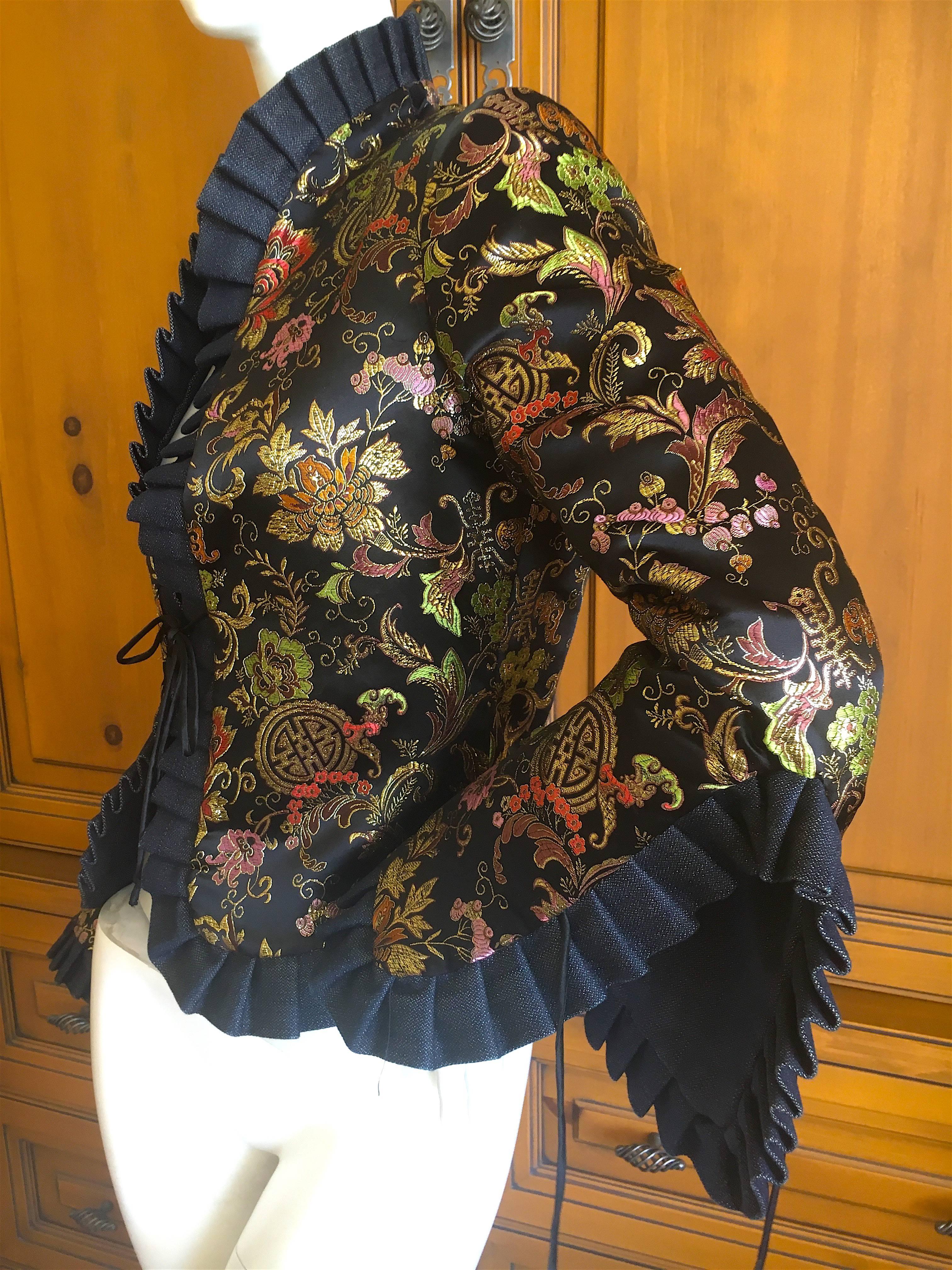 Jean Paul Gaultier Femme Golden Chinoiserie Brocade Reversible Ruffle Jacket.
This is a wonderful piece, with flamenco ruffles at the cuff and collar.
Reversible to denim. This has the Gaultier tags on the brocade side, but will need to be removed
