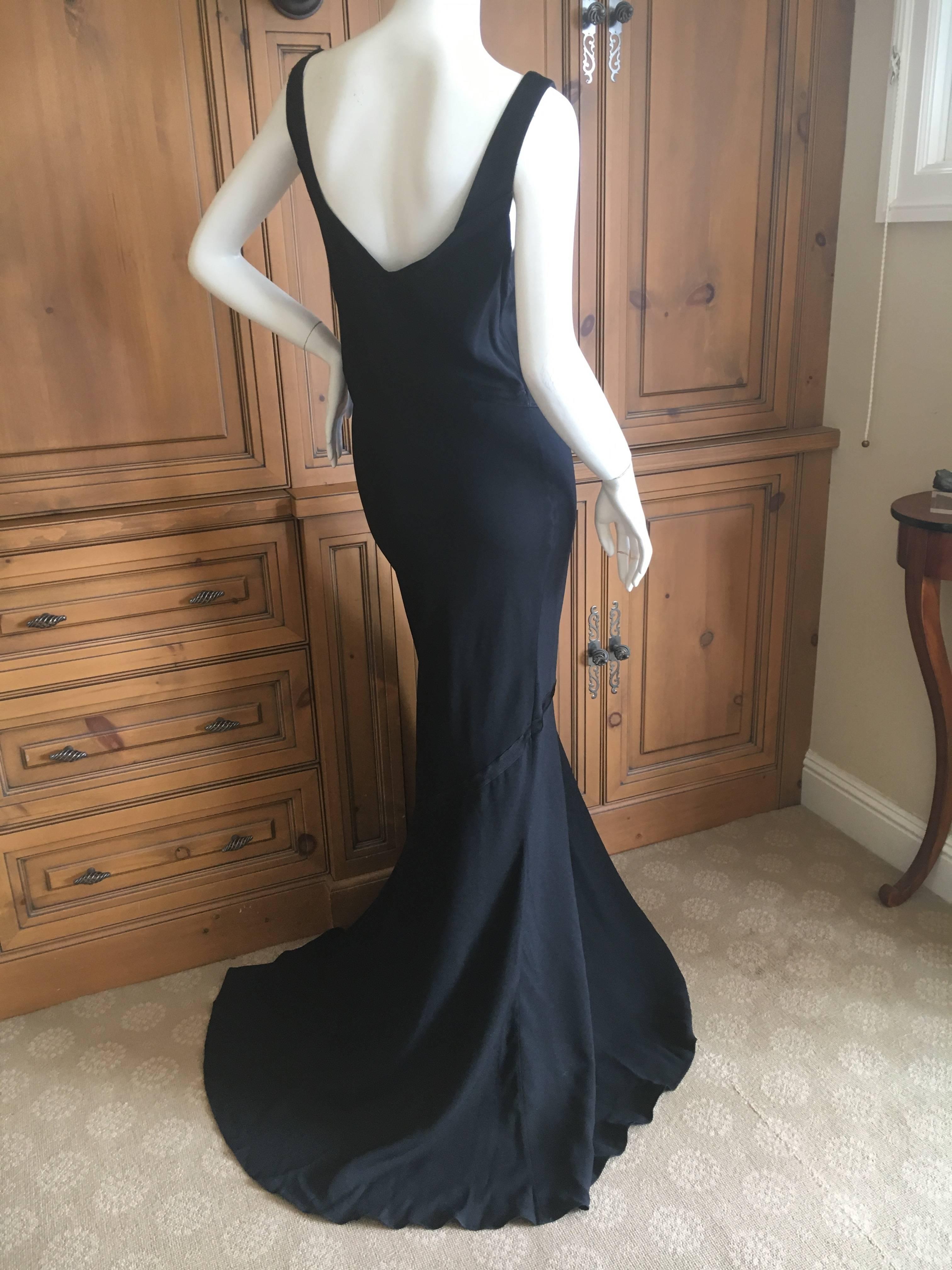 Wonderful long black evening dress from John Galliano, from 2001
This is exquisite , the photos don't capture the contrast in the finishes of the fabric, there are X's in a polished fabric that contrasts with the dress.
This has never been worn and