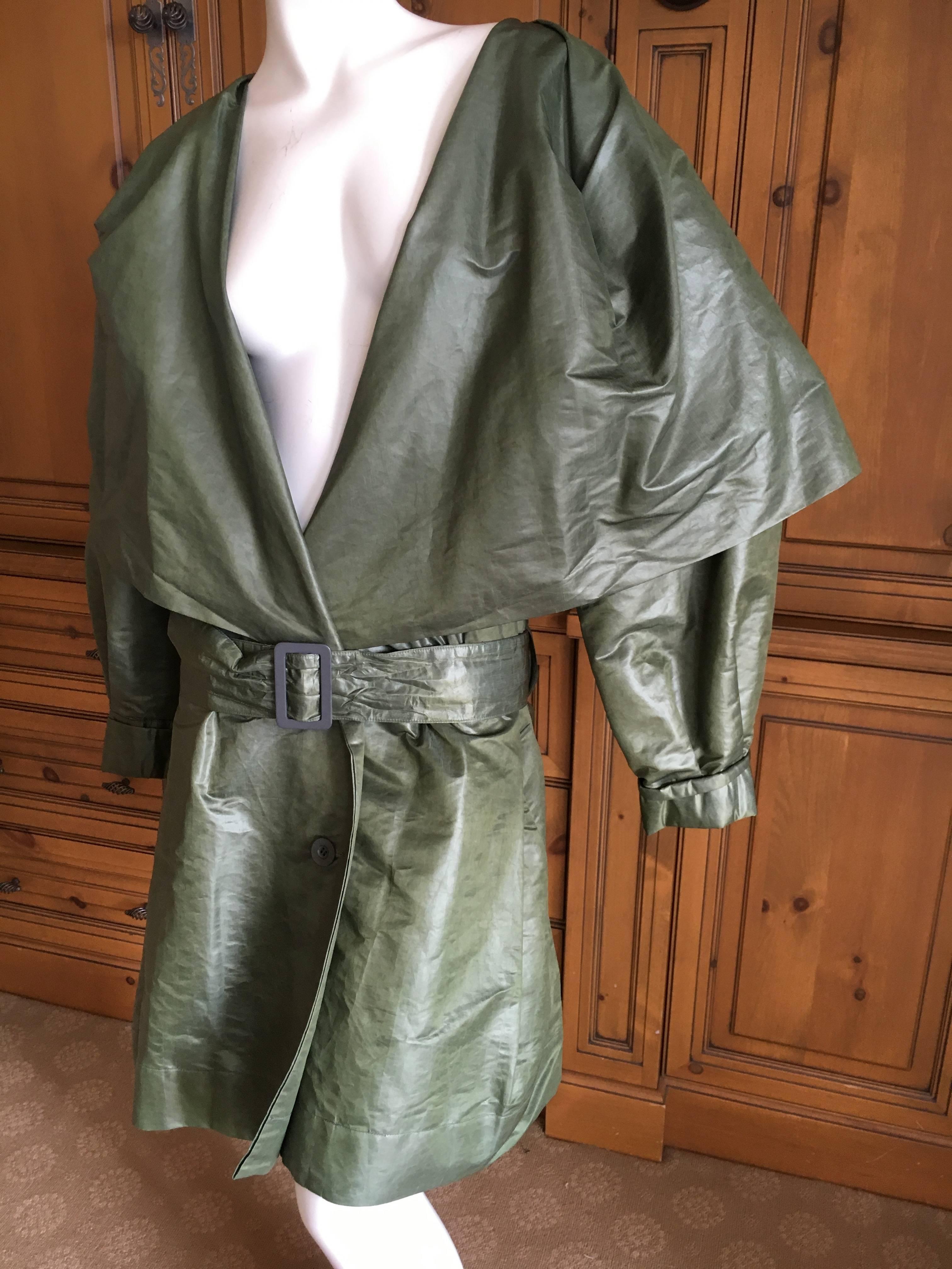 Early 1980's  Label Issey Miyake Belted Double Breasted Trench Coat with Cape Collar.
This is a treated, coated Poly fabric.
MArked size M, it is cut very generously.
Bust 62"
Waist 60"
Length 40"
