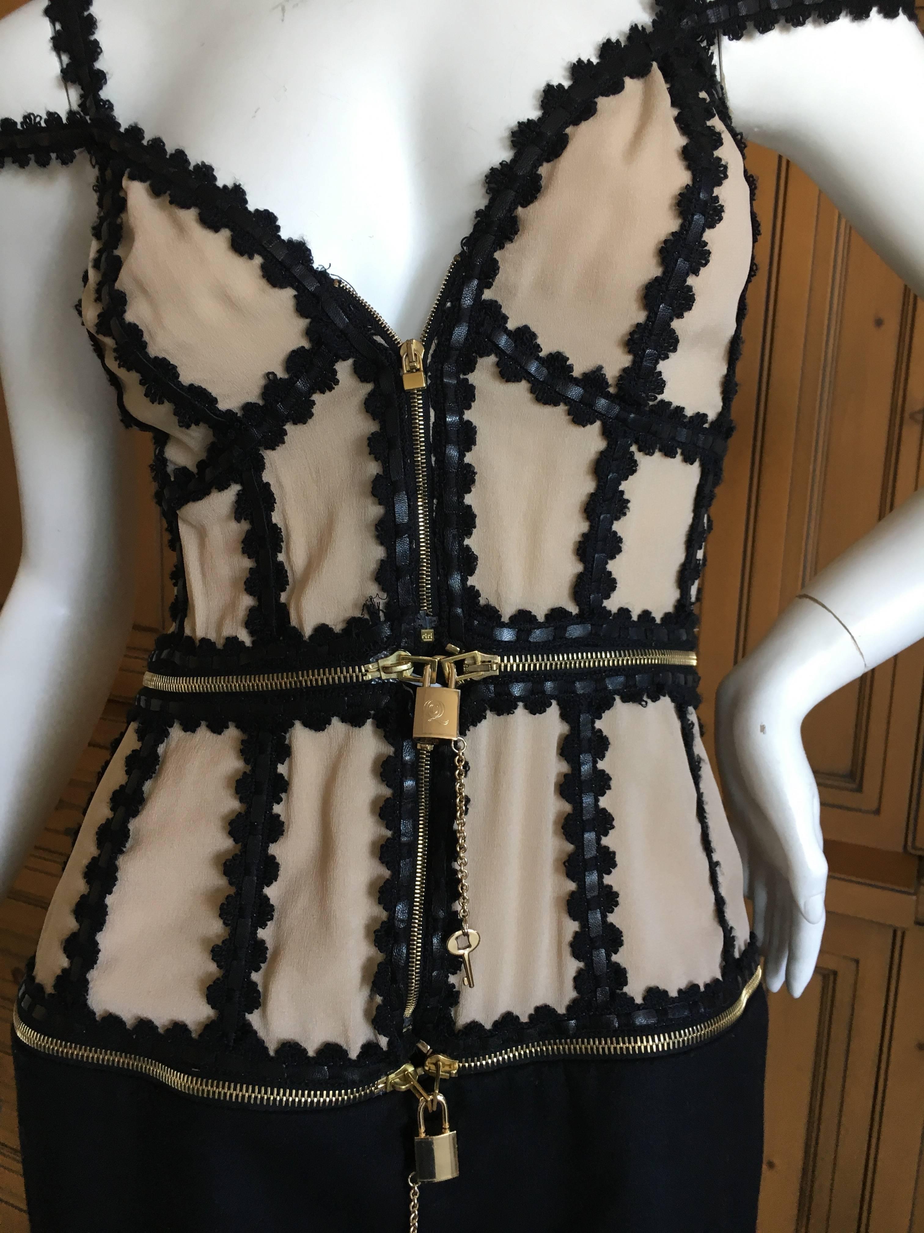 Alexander McQueen Rare Zip Apart Transformer Dress with All Locks & Keys.
This is pre death McQueen, and very rare to find with all the locks and keys intact.
This zips apart in to three separate pieces, fastened together with working locks &
