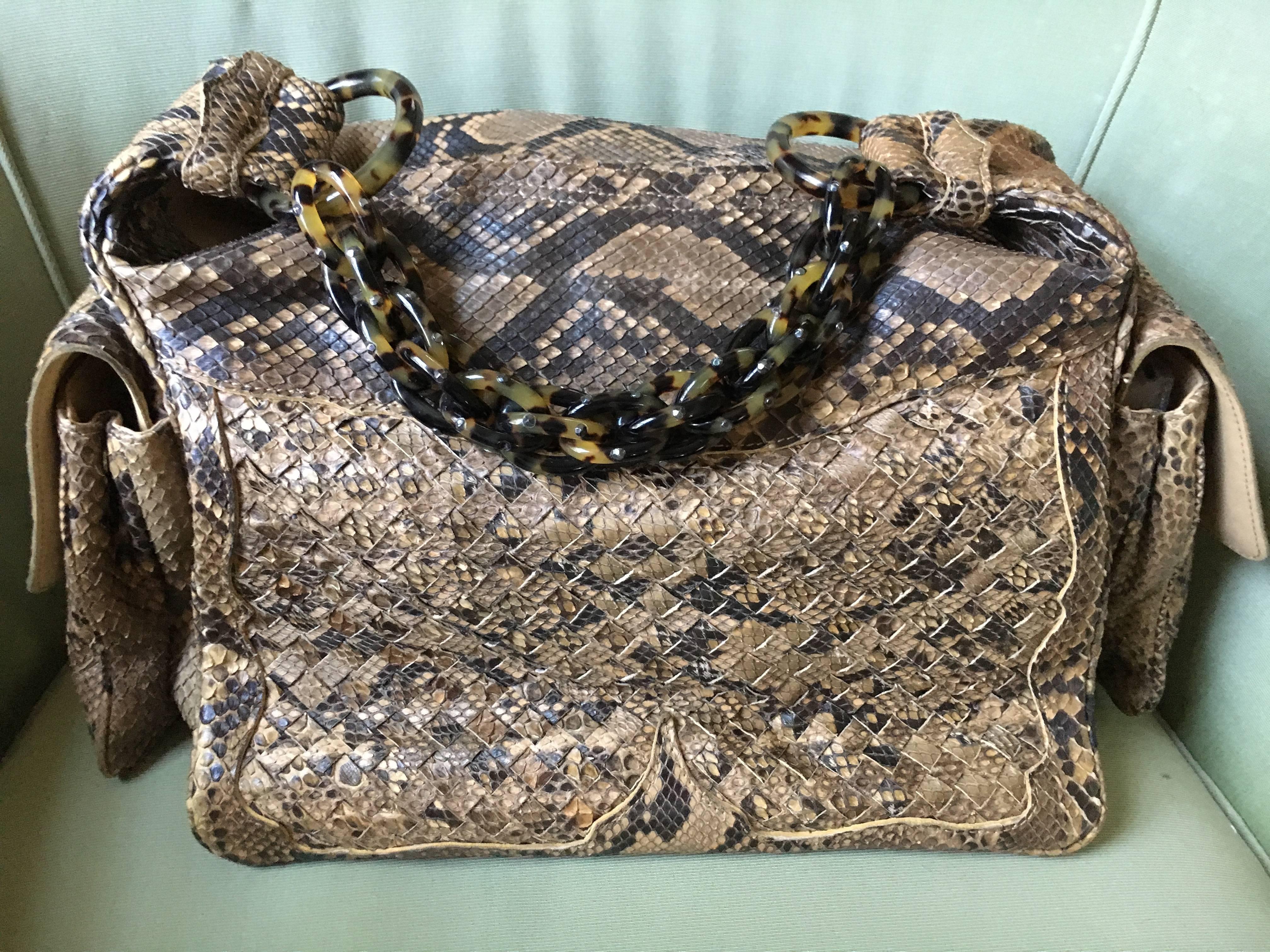 Bottega Veneta Rare Python Crocker Bag with Tortoise Chain Retail $5400.

This beauty is in neutral tones of python, with a suede interior and tortoise chain strap.

12