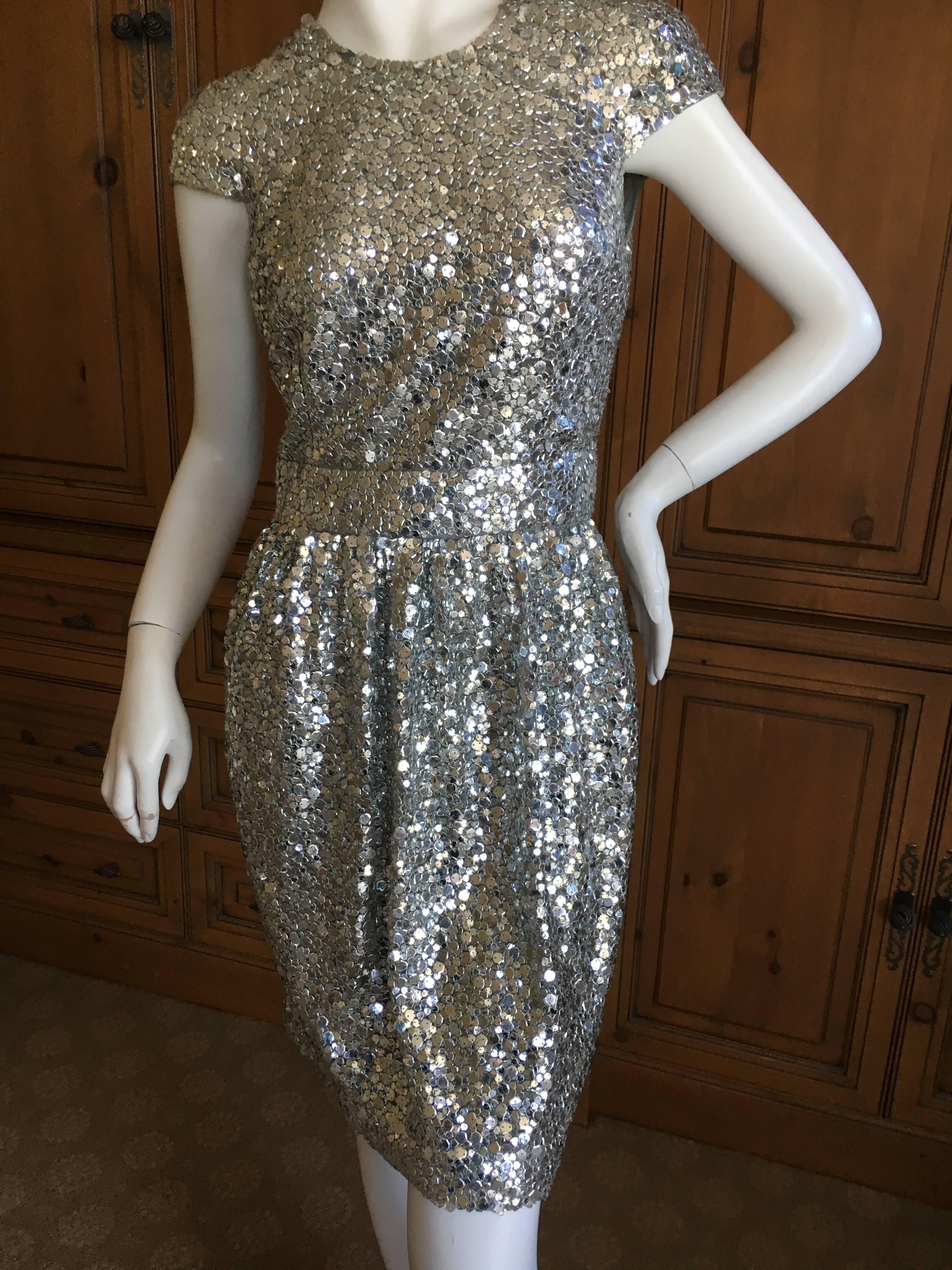 Sweet Silver Sequin Cap Sleeve Cocktail Dress from Naeem Khan.
Lined in silk, the size tag is no longer on the dress, it is a size 2
Bust 34