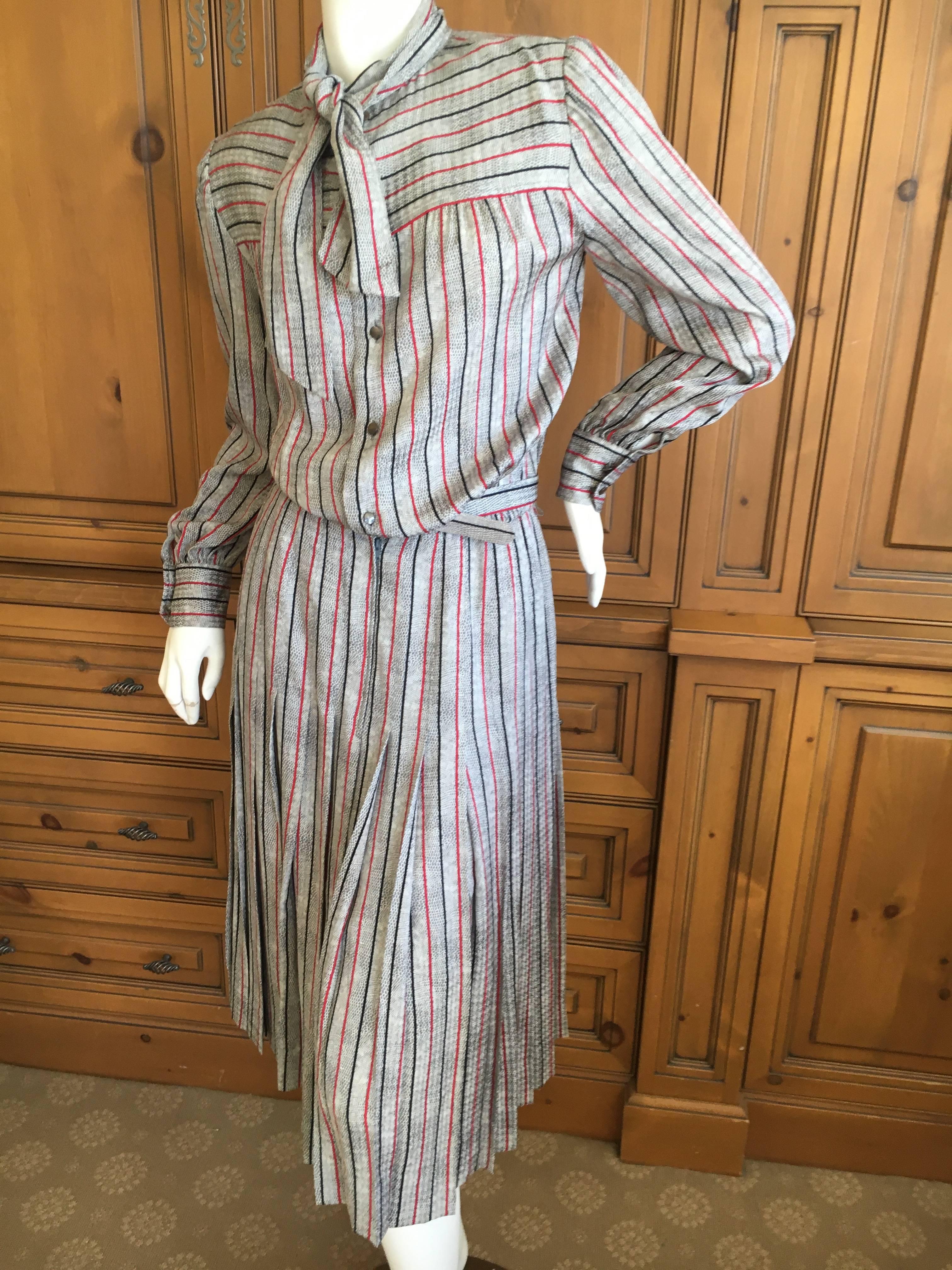 Delightful silk belted day dress in a very pretty stripe snake pattern.
Skirt is pleated, belt is leather lined.
The quality is superb, they just don't make them like this anymore.
Size 40
Bust 40"
Waist 28"
Hips 42"
Length