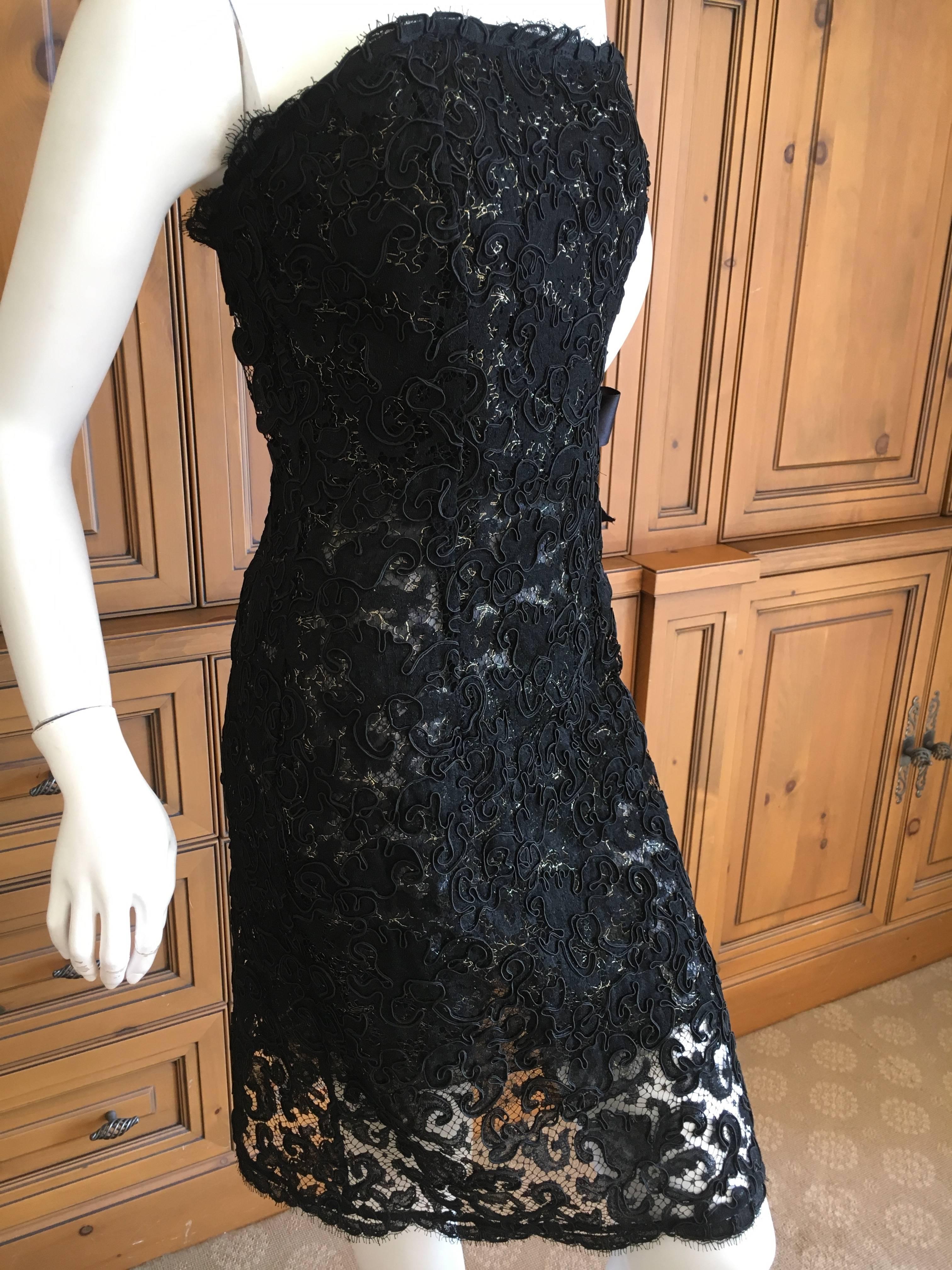 Beautiful double layer lace wrap dress with three bow's on the side from Yves Saint Laurent Rive Gauche.
The first layer of lace is gold edged black lace, with black lace overlay.
Here is boning in the dress.
Hard to photograph, but stunning in