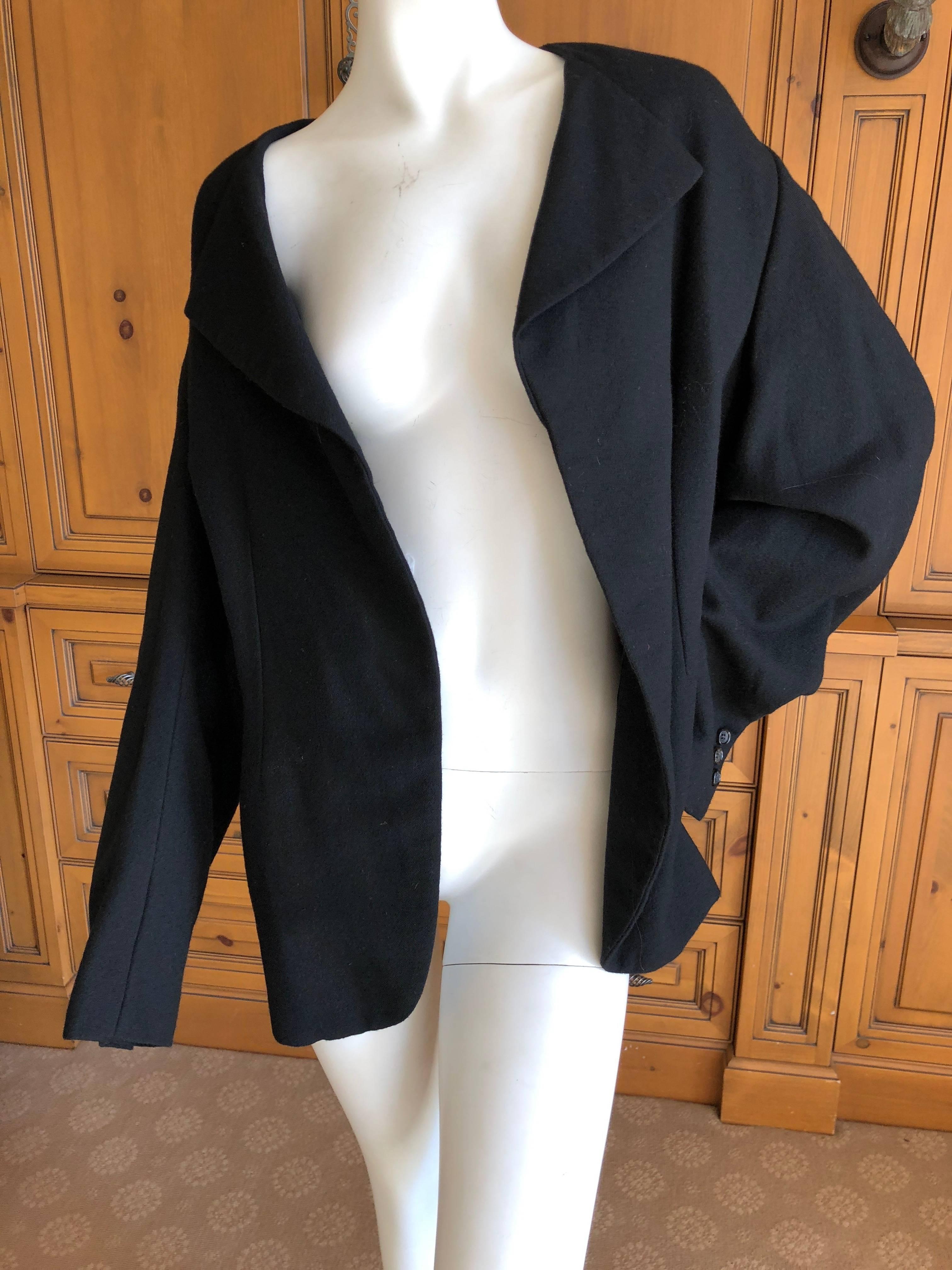 Comme des Garcons 1996 Black Asymmetrical Jacket with Draped Back.
This is a very unusual jacket in that the front is totally asymmetrical .
The right shoulder is fitted so that the lapel is far to the right, hard to photograph or describe .
Dated