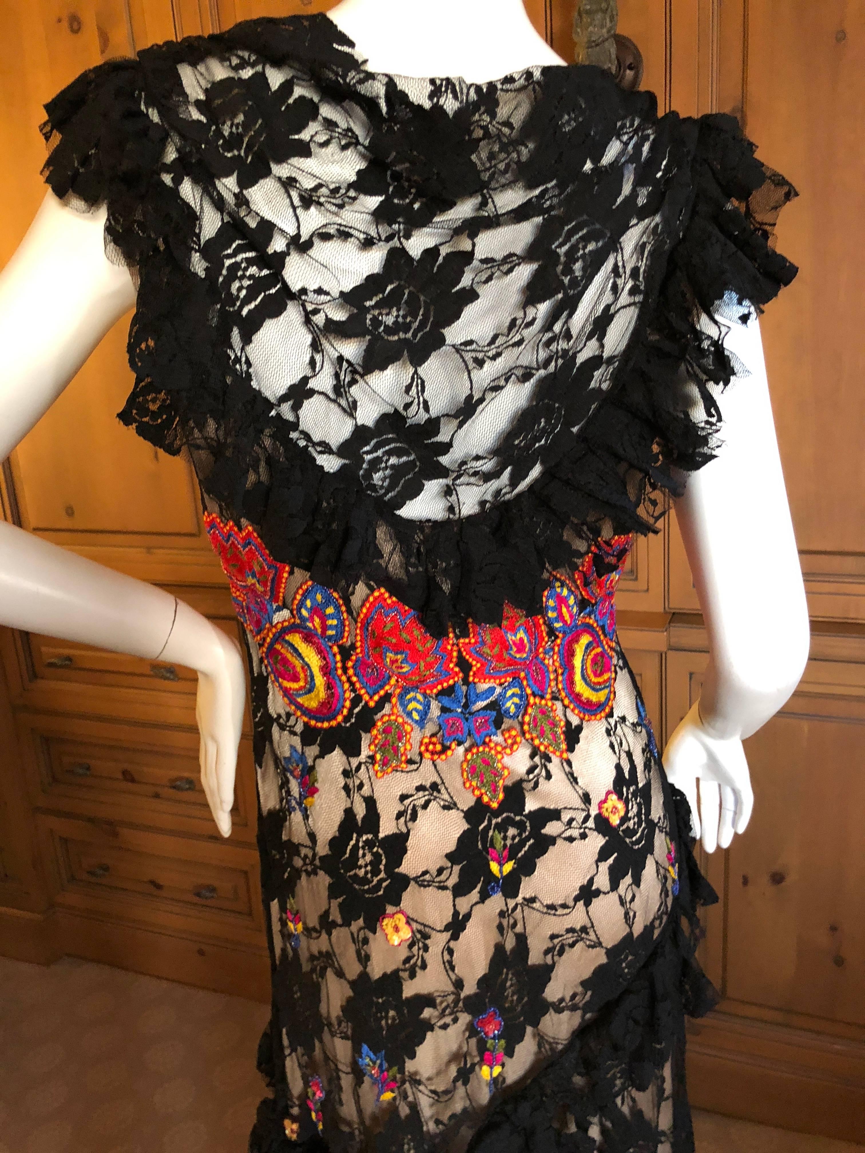  John Galliano amazing lace overlay dress embellished with wild multi color embroidery, and layers of lace ruffles cascading down the skirt.
This is exquisite, I have never seen this dress before, and I love it.
Size 42
 Bust 36