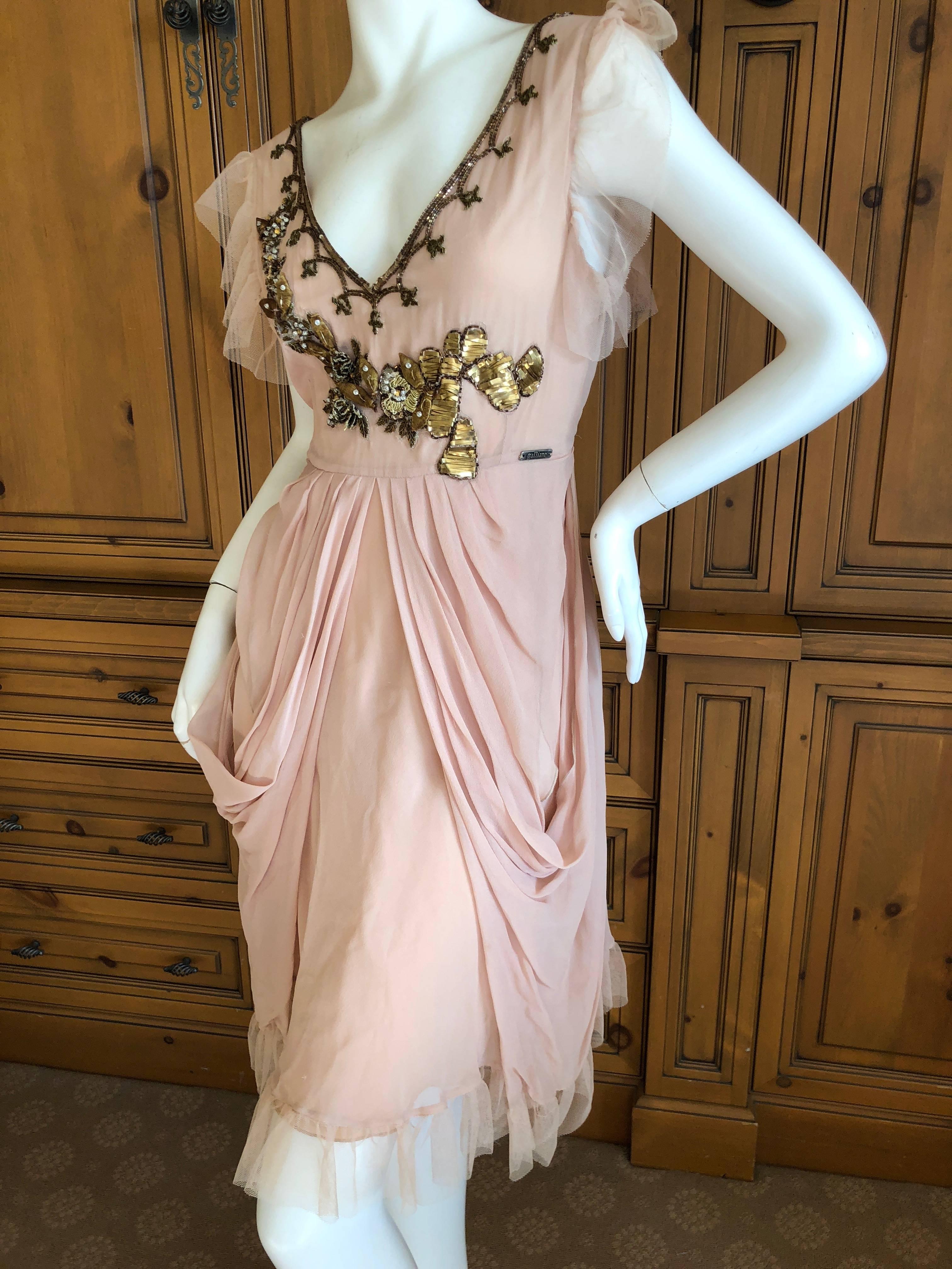 Wonderful tan cocktail dress with the most incredible embellishments from John Galliano .
New with tags.
Size 42
Bust 36