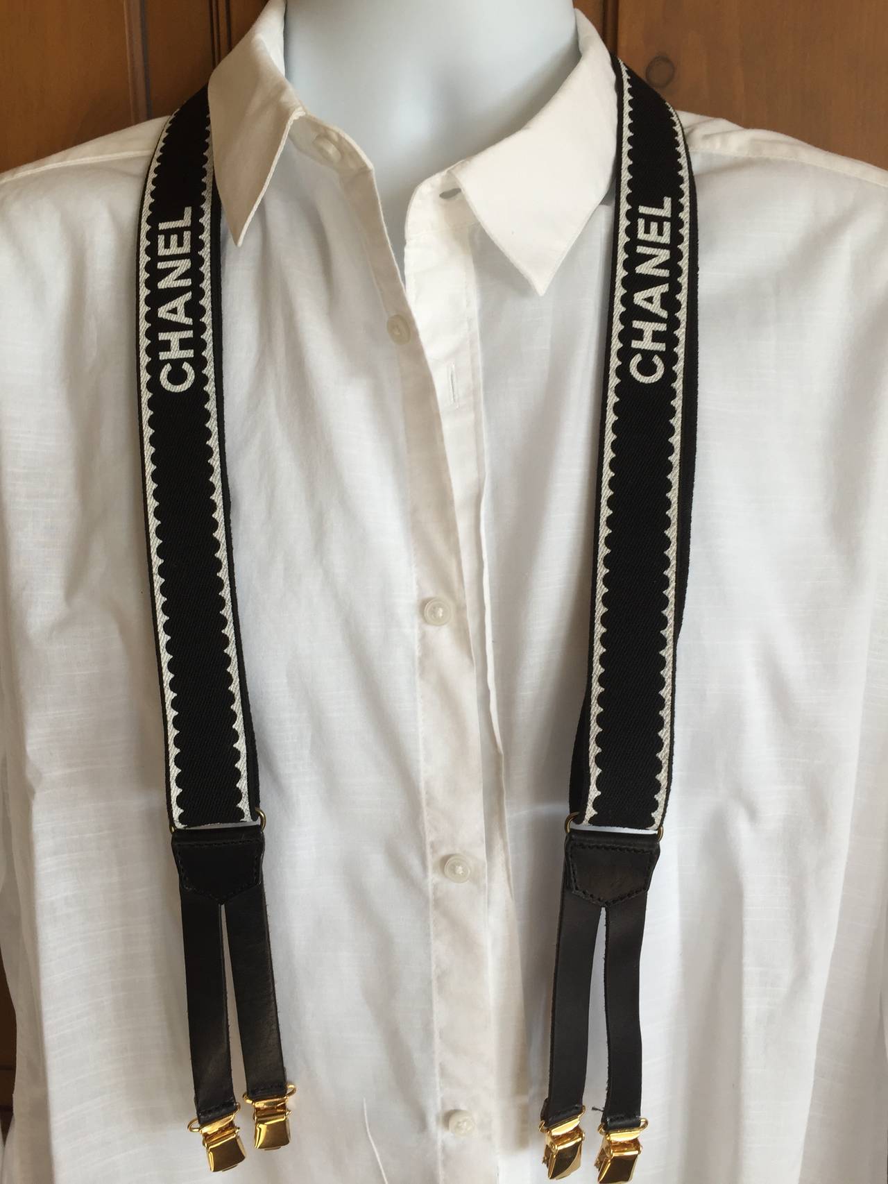 Wonderful vintage black and white suspenders from Chanel.
These are pristine, unworn, the elastic straps appear to have never been extended or used.
I did not extend them for the photo.
Marks on the leather on back are from storing against the