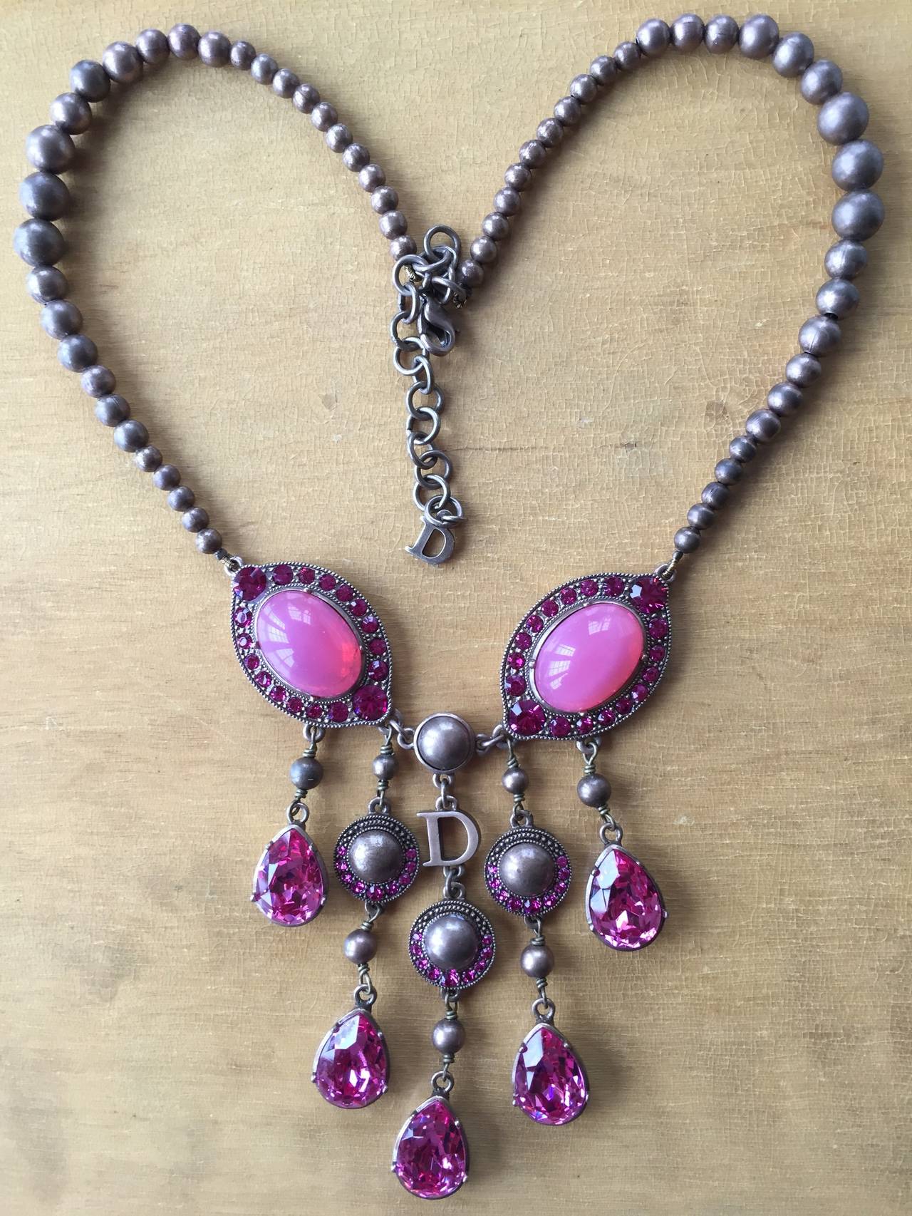 Beautiful rose color necklace from Christian Dior.
The metal is an antique brass , Swarovski crystal drops.
16