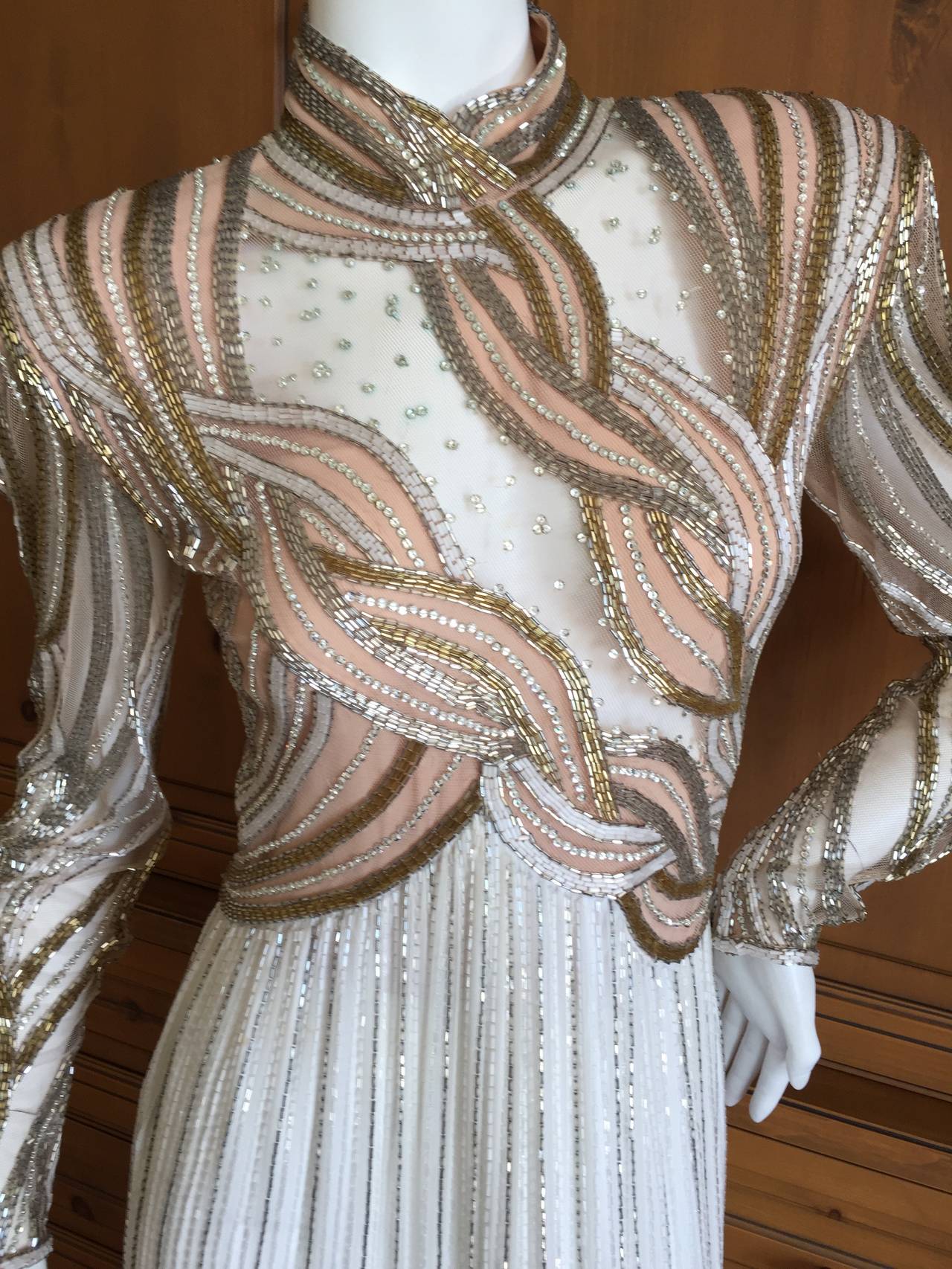 Bob Mackie Sheer Illusion 1970's Beaded Gown.
This is Mackie at his best, with sheer sections showing skin, and all the delicious beadwork in gold , silver and crystal.
I would estimate this at size 2-4 in todays sizing.
Bust 36