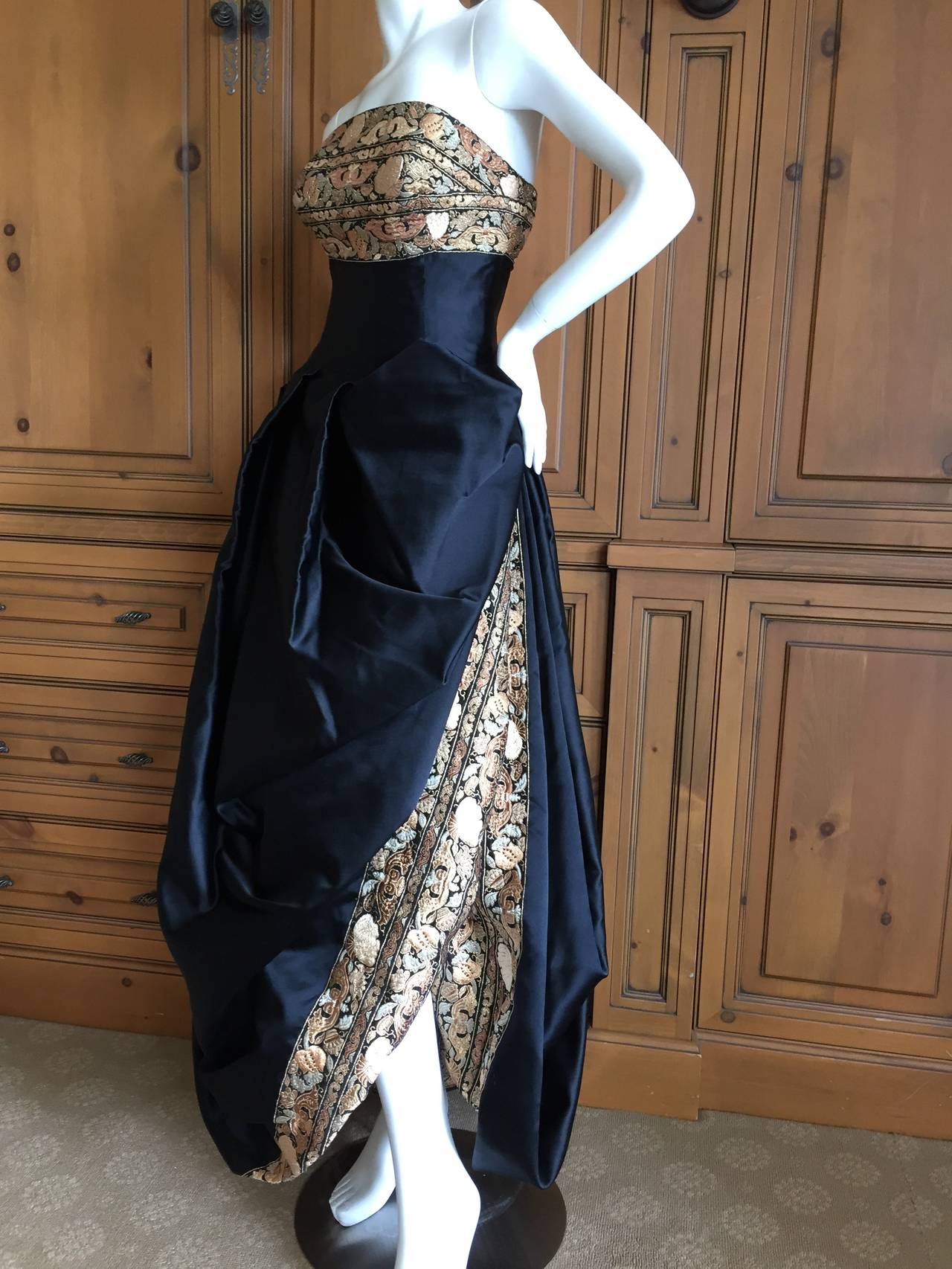 Exquisite Paul-Louis Orrier Paris Black Strapless Gown with Gold Brocade Accents and a Matching Shawl.
So seductive,  with a high slit on the skirt exposing the gold brocade.
This is quite small, I would estimate size 0-2 in todays sizing.