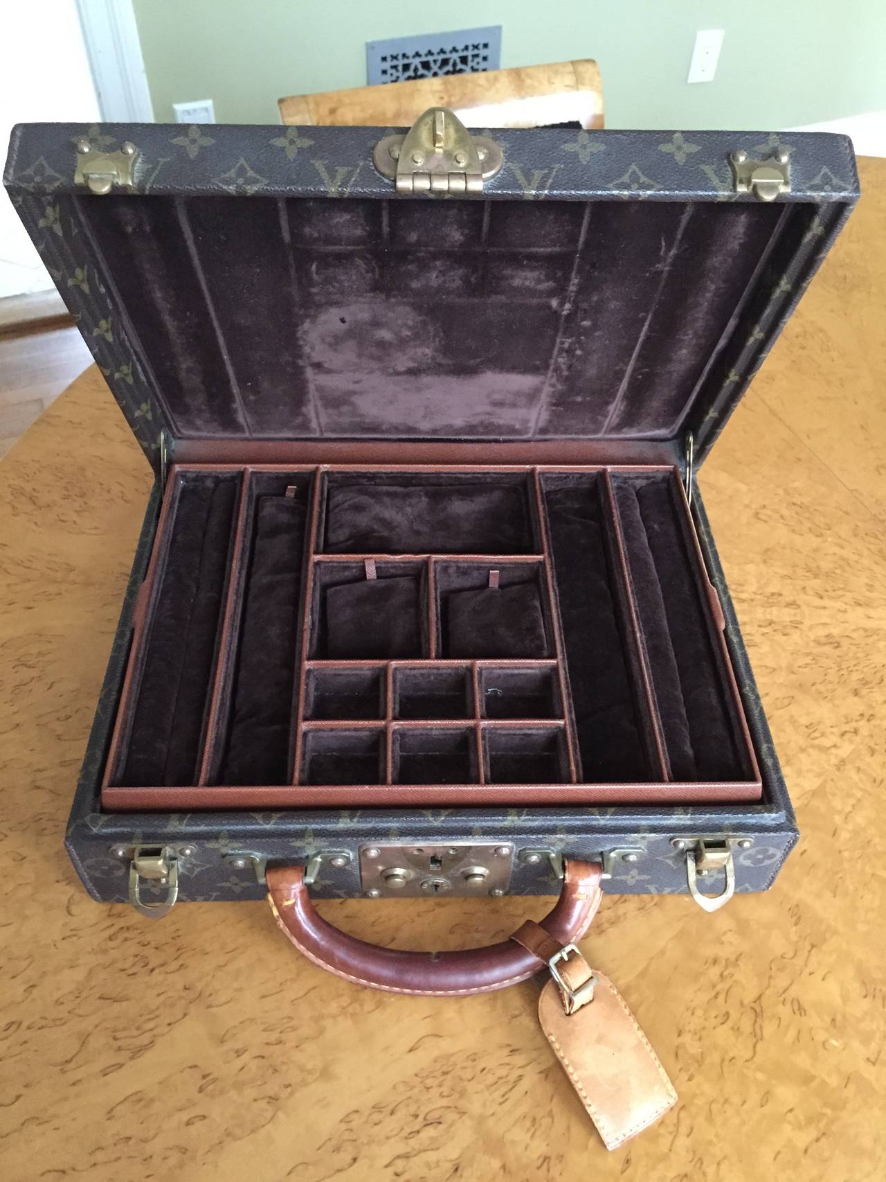 Louis Vuitton Vintage Travel Case for Fine Jewelry.This has been lovingly used to travel the world, and has a wonderful patina.
There are a couple of small dings on the edges of one side, please see the detail photos .
Comes with key and name tag.