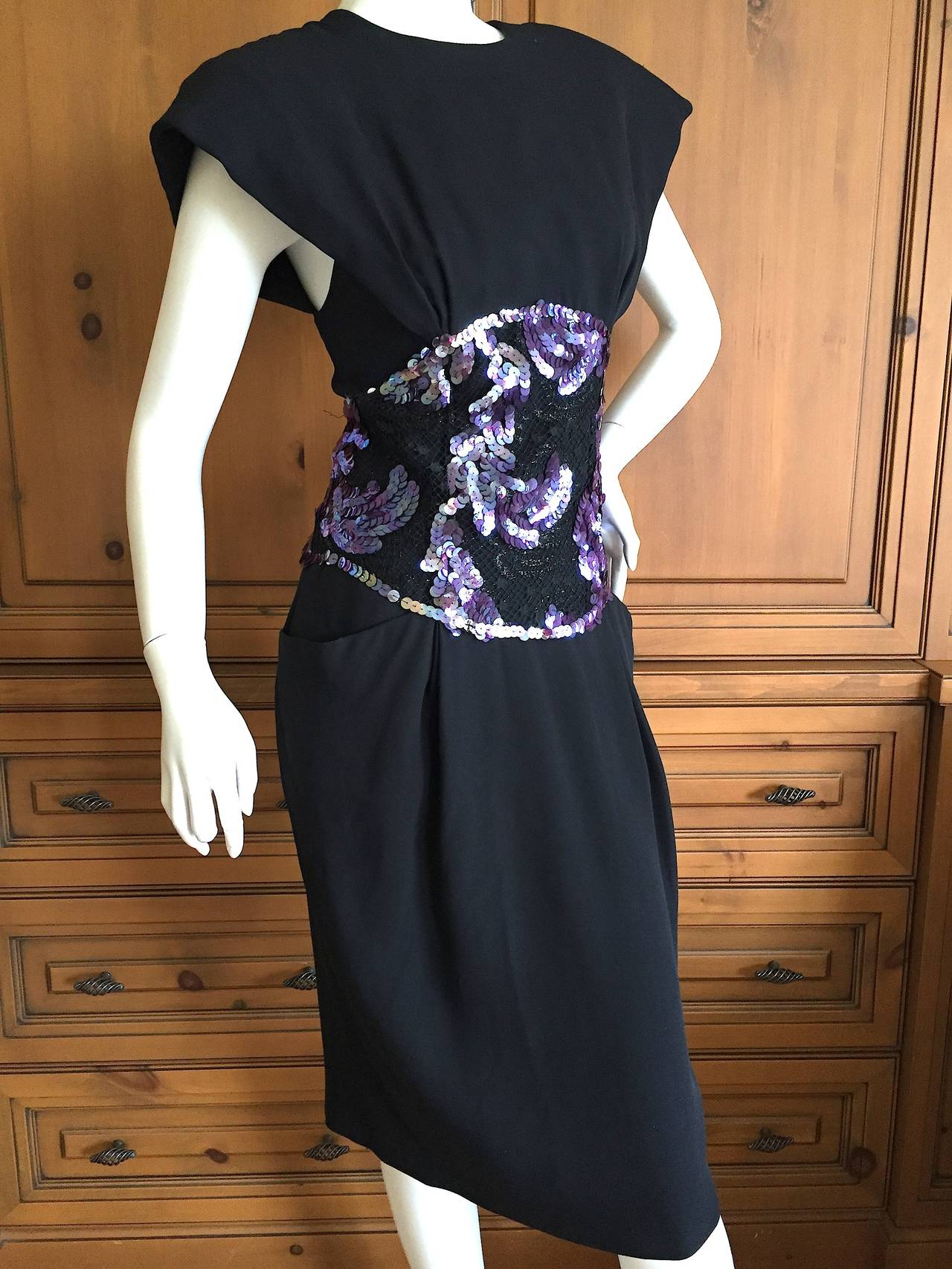 Beautiful black crepe dress from Geoffrey Beene circa 1985.
There is a sequin band across the waist  like an Obi Belt.
Size 10
Bust 38
