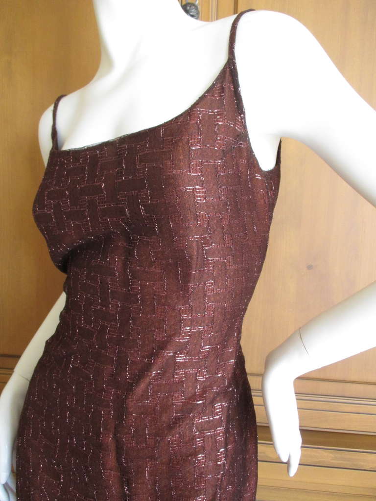 Chanel Sheer Column Dress with Metallic Accent's
Sheer brown netting accented with a pattern of copper metallic threads
9 CC Chanel buttons down the back, whic zippers, the buttons are ornamental.
sz 40 
From Autumn 99
Nylon /Poly blend