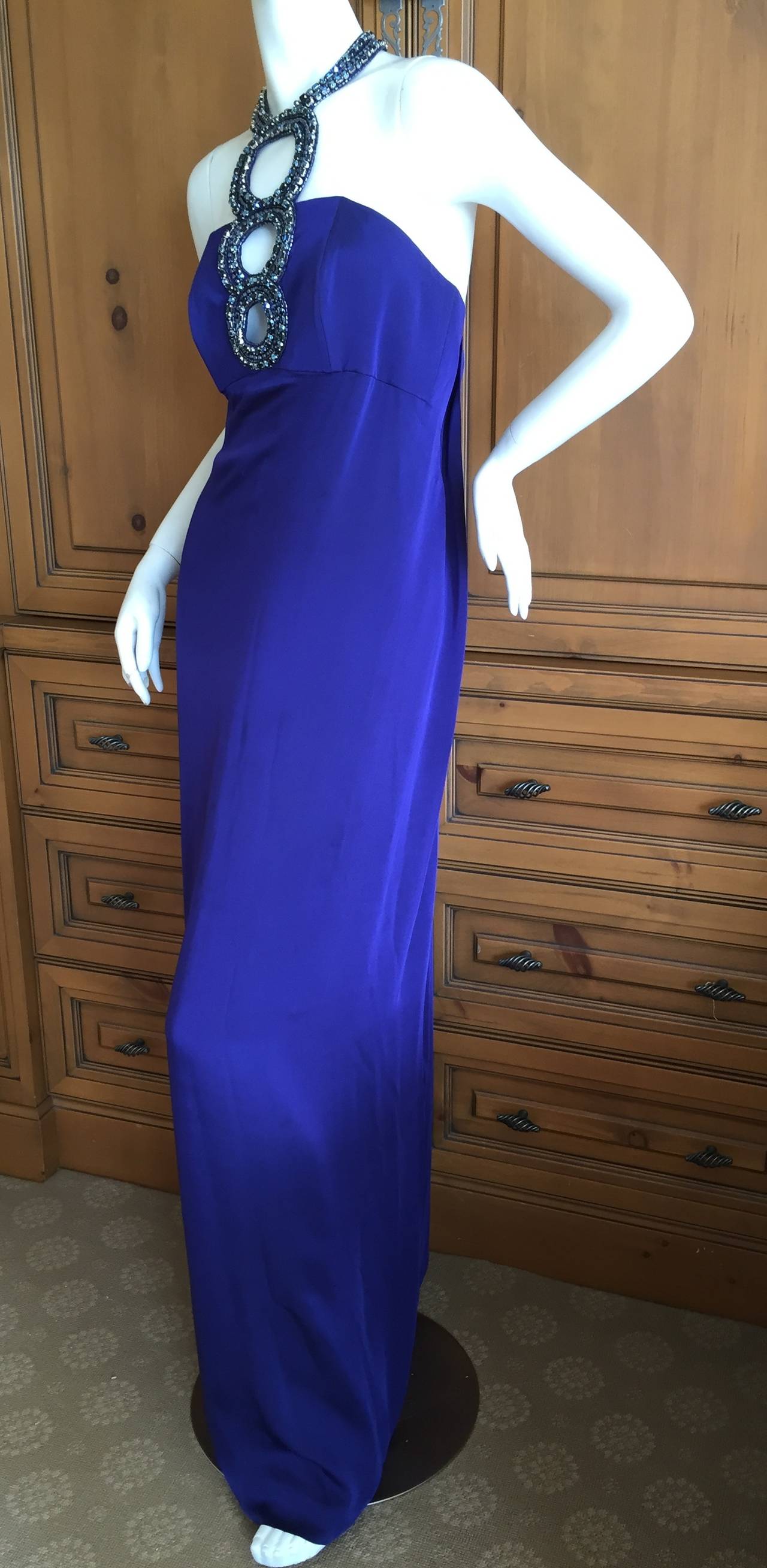 Beautiful blue silk dress with dramatic jeweled keyhole at bust and neck.
This has never been hemmed and is very long 65