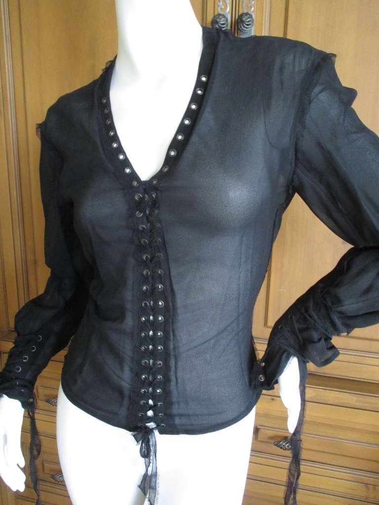 YSL by Tom Ford 2002 Sheer Black Corset Lace Top
This is so subtle, the back is totally corset laced with a sheer cape like panel over it. 
There is no size tag, it is small 34-36 
Bust 36
Length 22