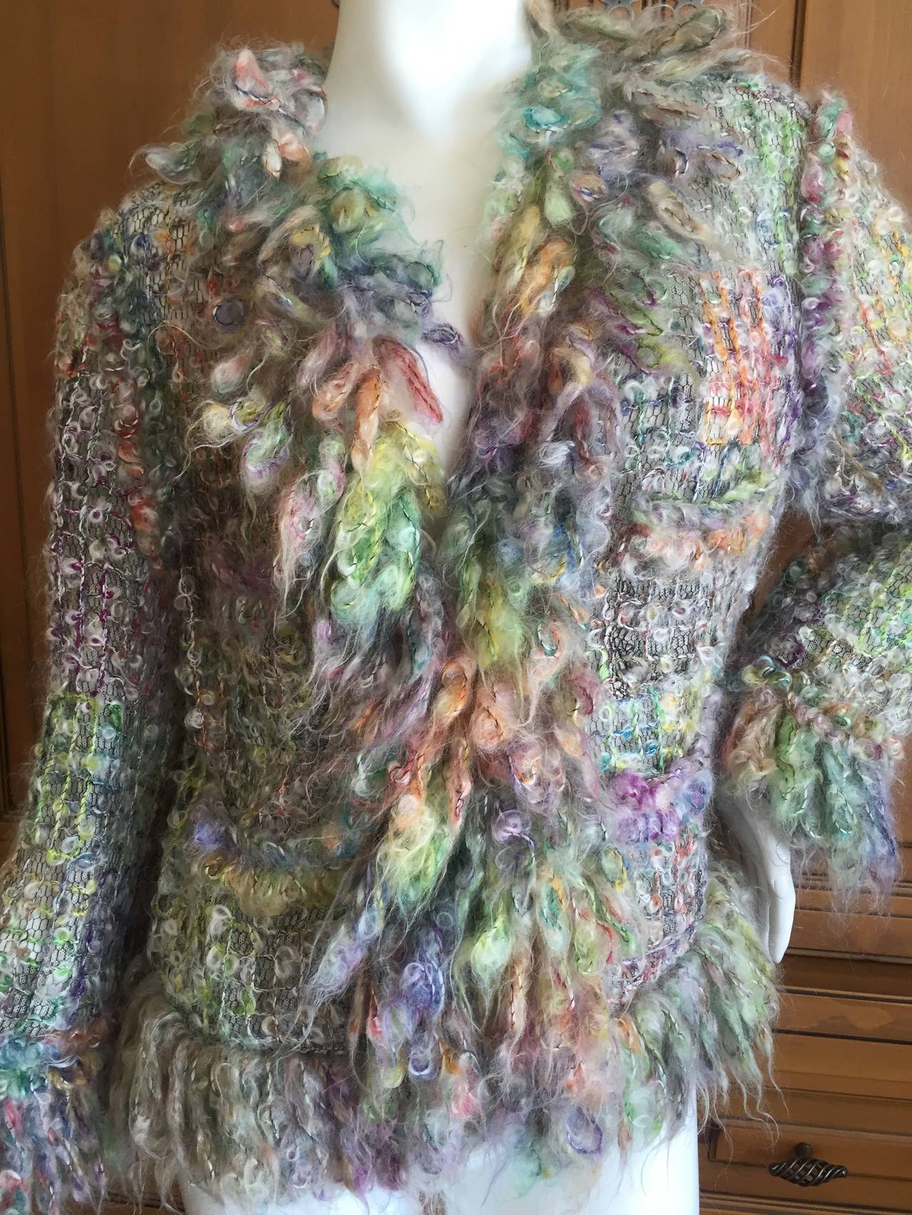 Chanel Delightful Multicolor Fantasy Woven Jacket with Wooly Trim.
This is so chic, it is a trompe-l'œil of tweed.
Very loosely woven colorful wool (?) on a sheer cotton net shell.
With a wonderfully wooly fringe,
This is much prettier in