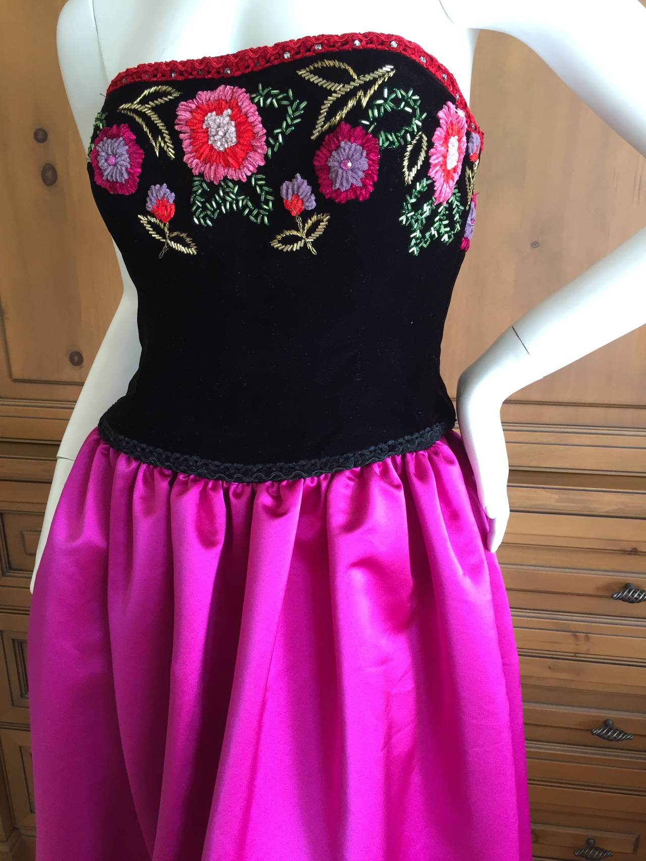 Victoria Royal Wonderful Folkloric Embroidered Vintage Ball Gown.
Black velvet bodice with Mexican Folkloric pattern embroidery with a hot pink silk skirt.
Victoria Royal Ltd was a dress company in Hong Kong which produced evening wear for the